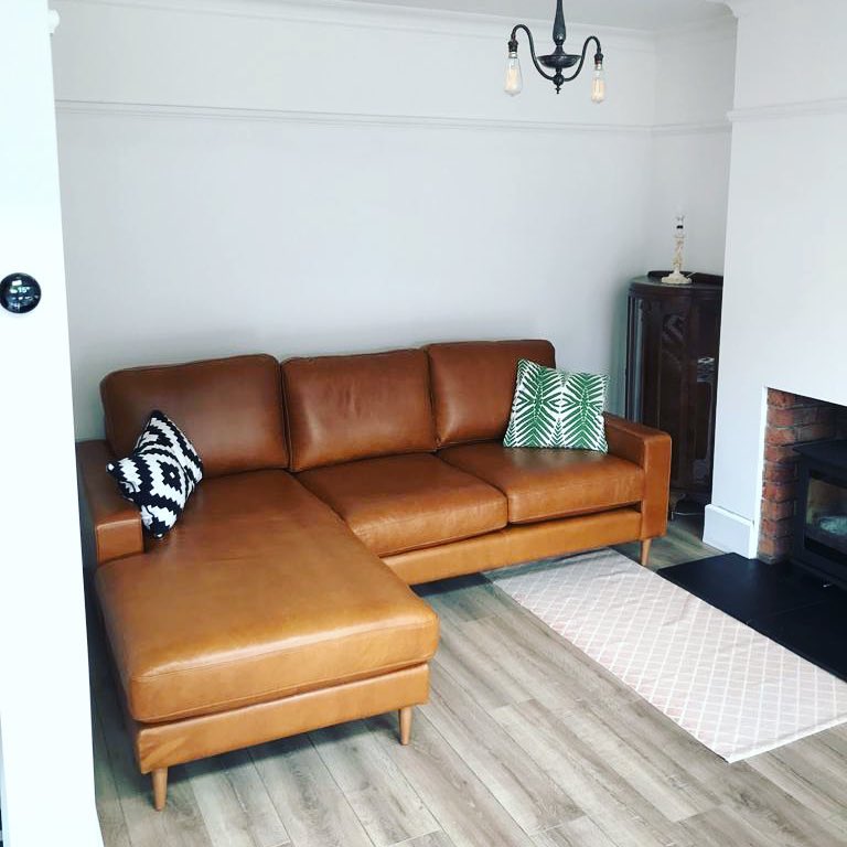 15. Choose a Compact Leather Sofa with Raised Legs