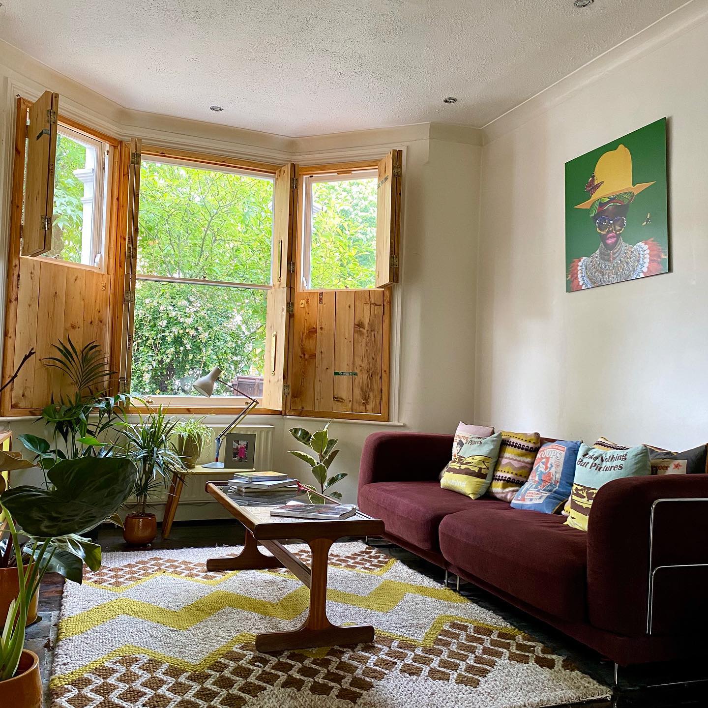 9. Use a Geometric Rug to Brighten Burgundy Seating