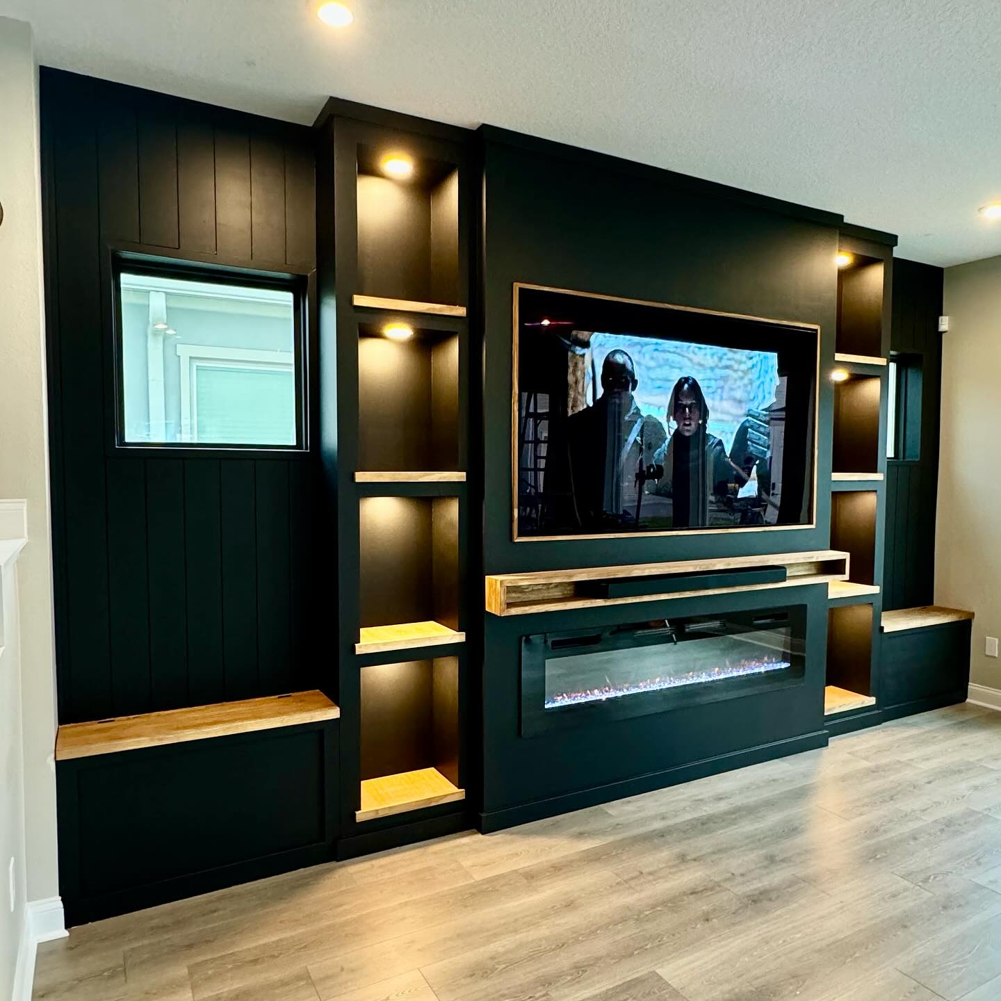 4. Black Paneling With Warm Wood Breaks