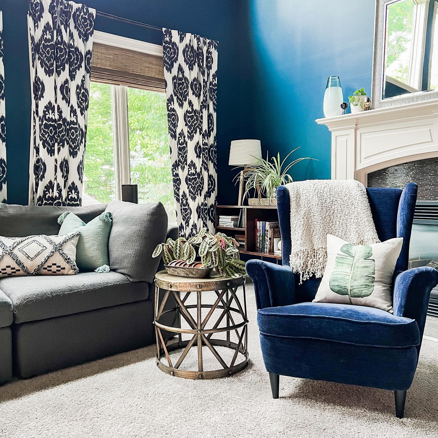 13. Connect Blue Walls and Gray Seating with Patterned Curtains
