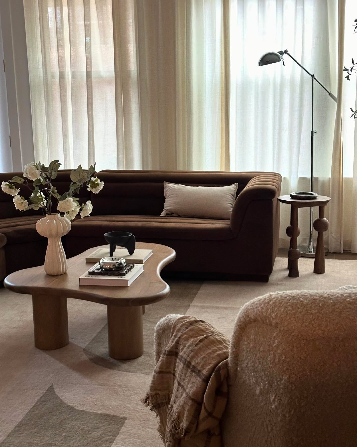 Echo a Curved Brown Sofa with Sculptural Tables