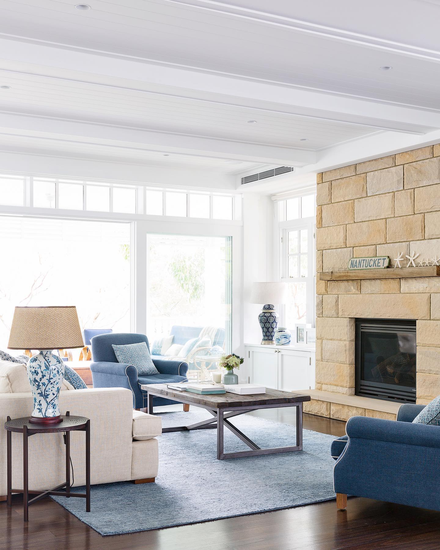 Warm Blue Seating with a Sand Colored Fireplace
