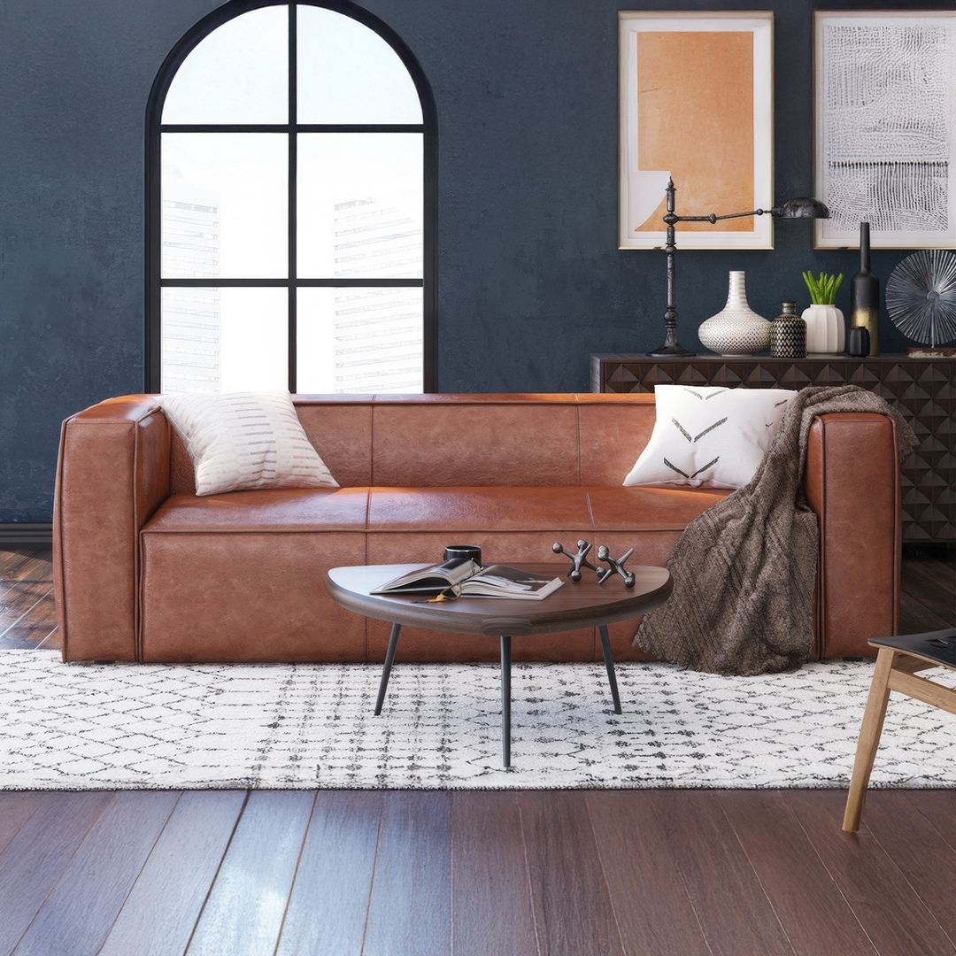 3. Set a Cognac Sofa Against a Deep Blue Wall