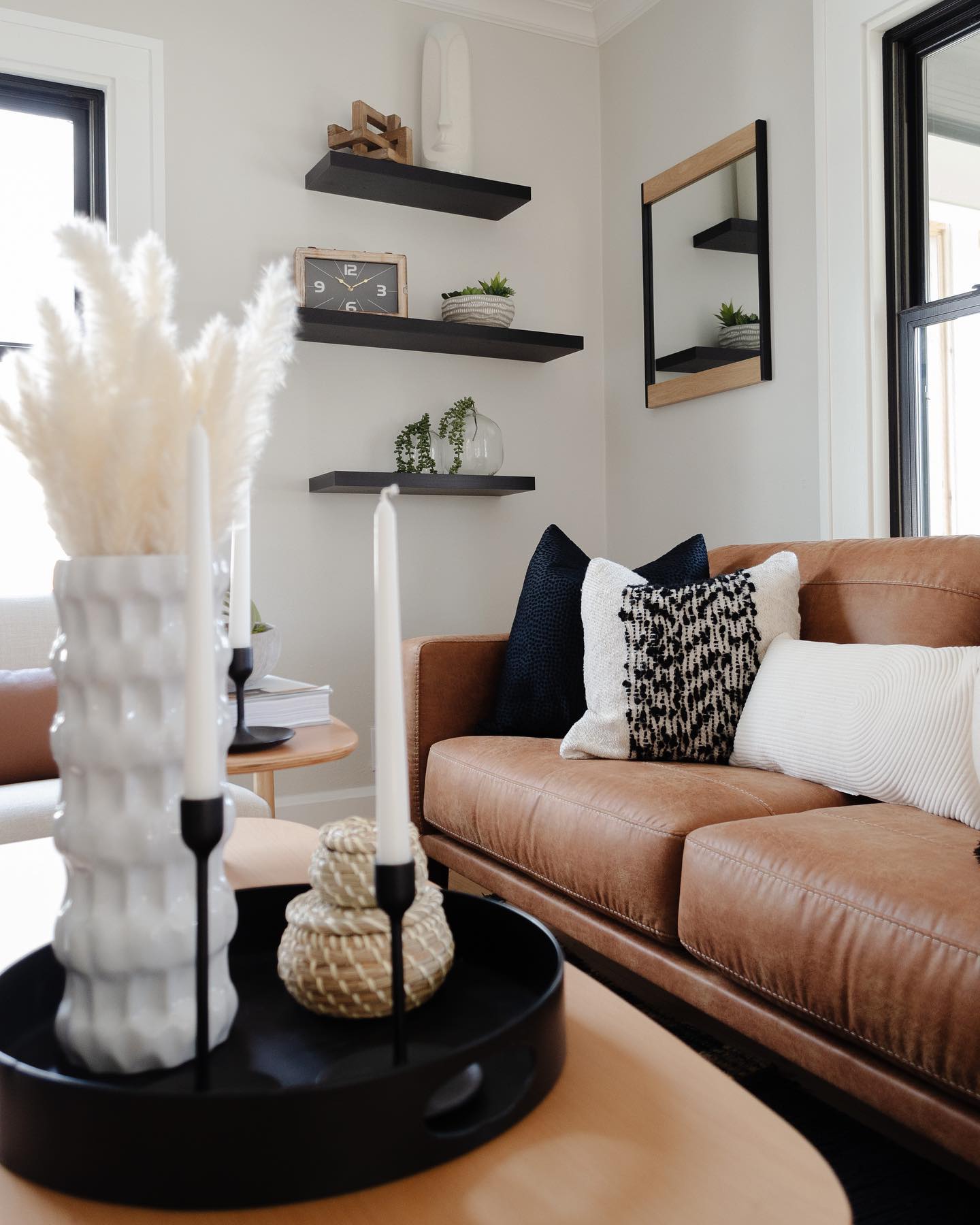 13. Connect Leather Seating With Black Floating Shelves