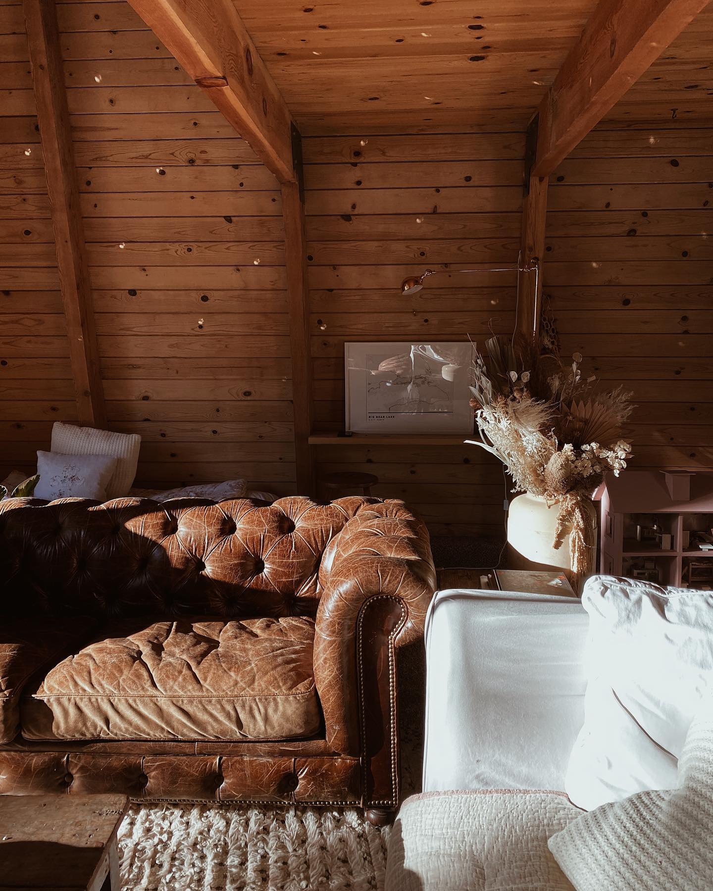 15. Balance a Tufted Leather Sofa With Pale Cabin Textures