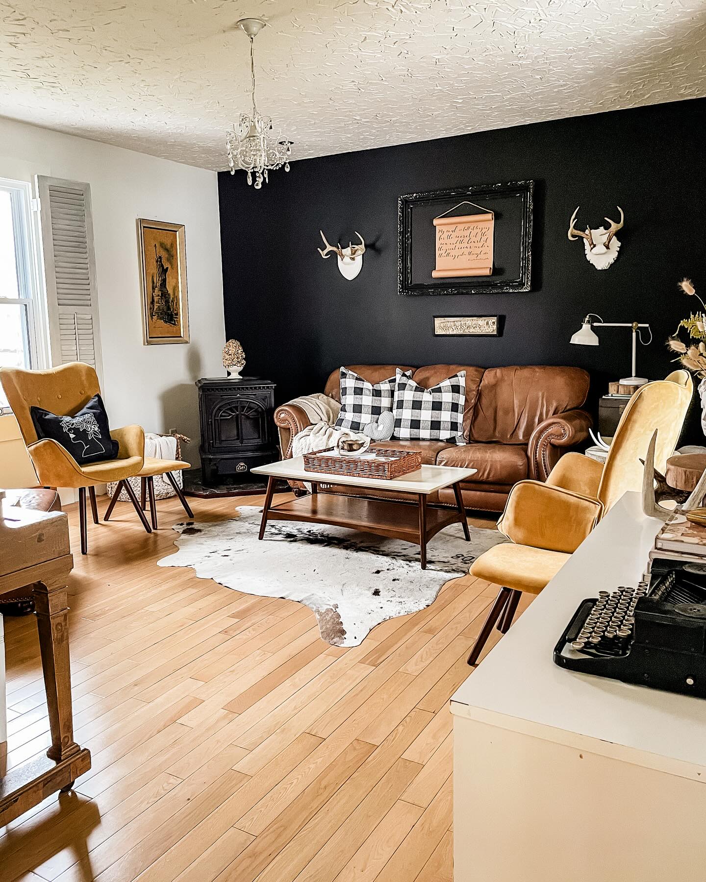 18. Warm a Black Accent Wall With Mustard Chairs