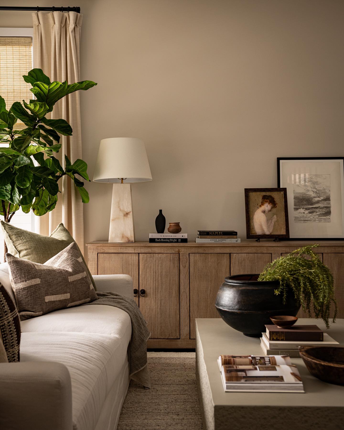 3. Lean Artwork on a Warm Wood Sideboard