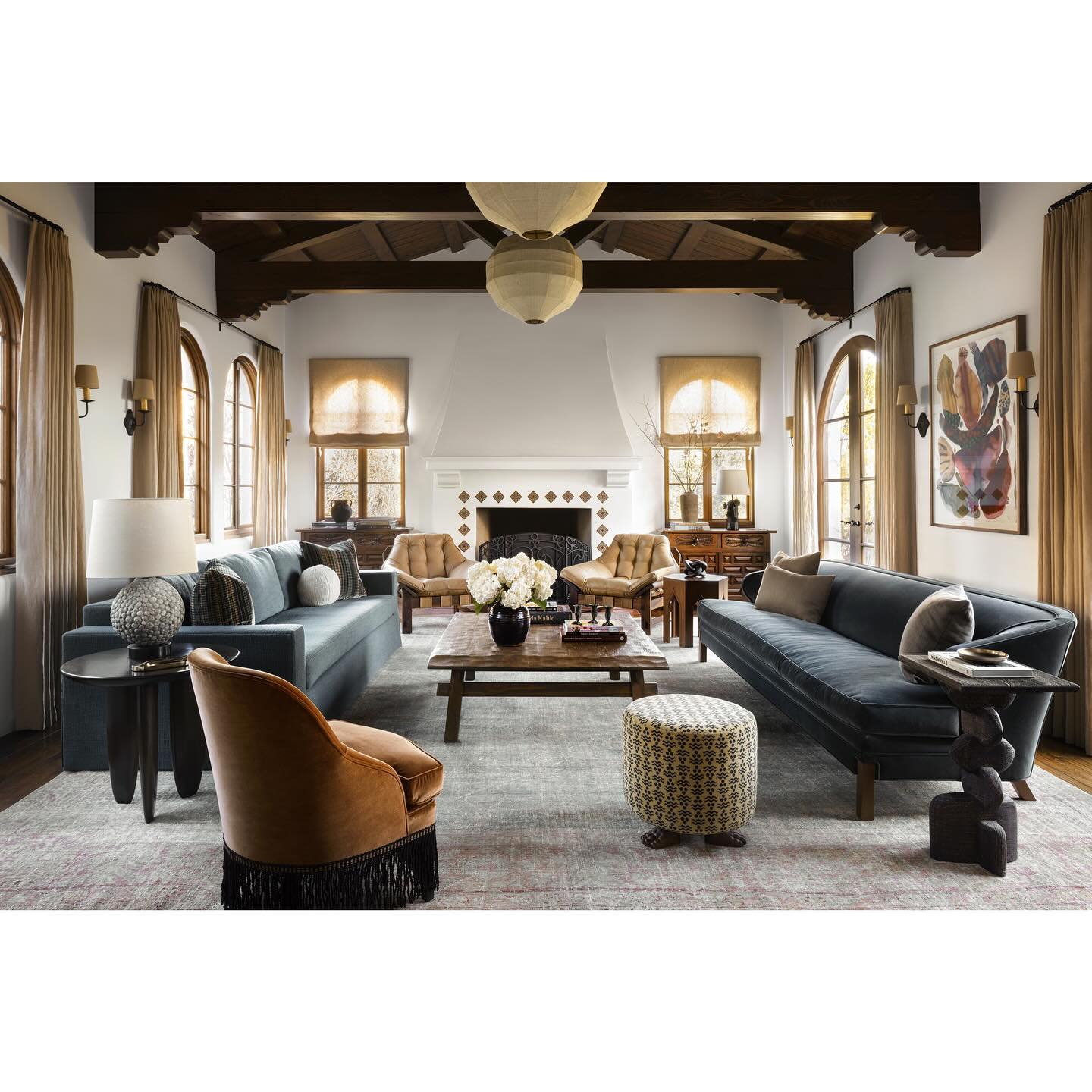 4. Pair Muted Blue Sofas Beneath Dark Beams