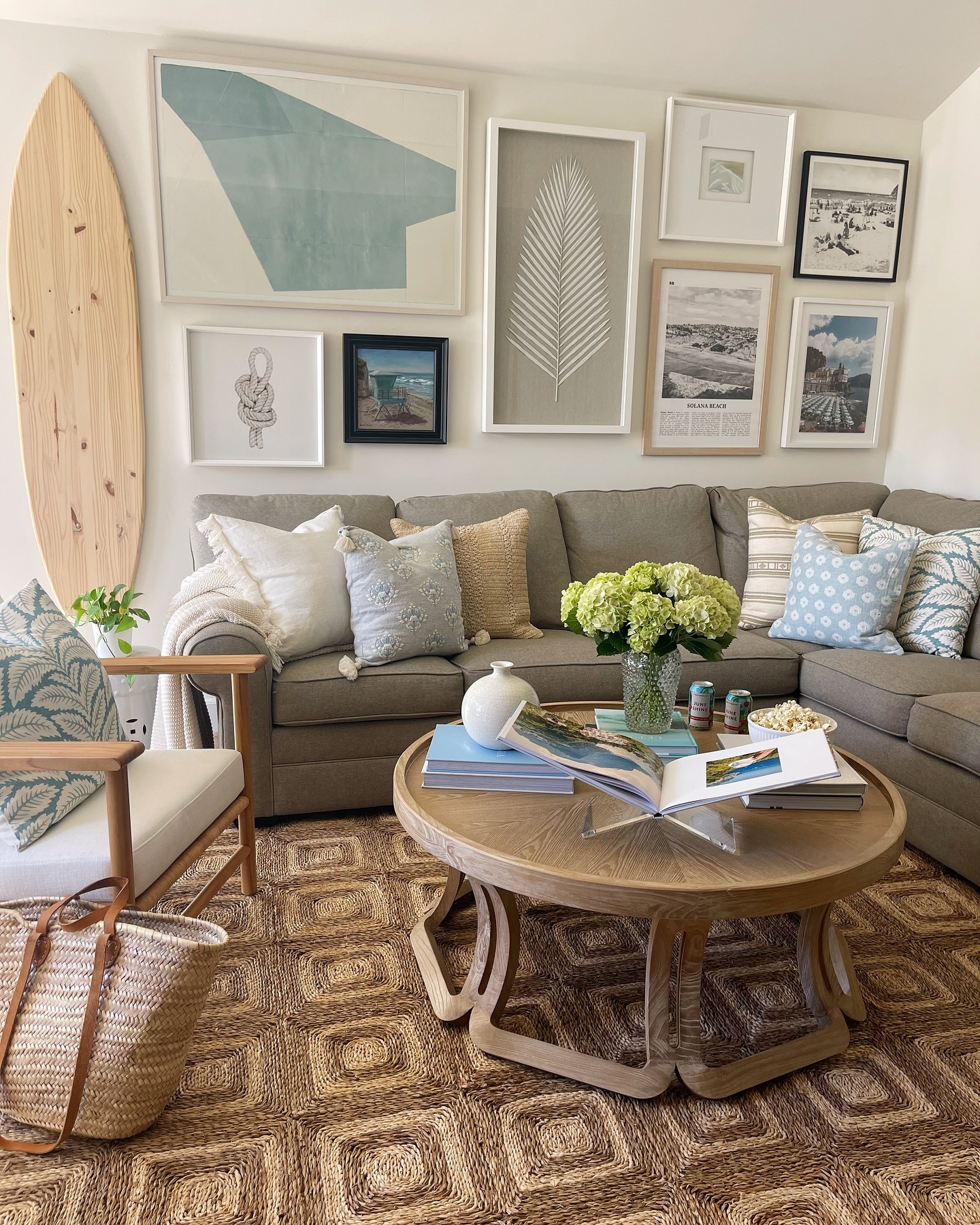 7. Build a collected coastal gallery above an olive sofa