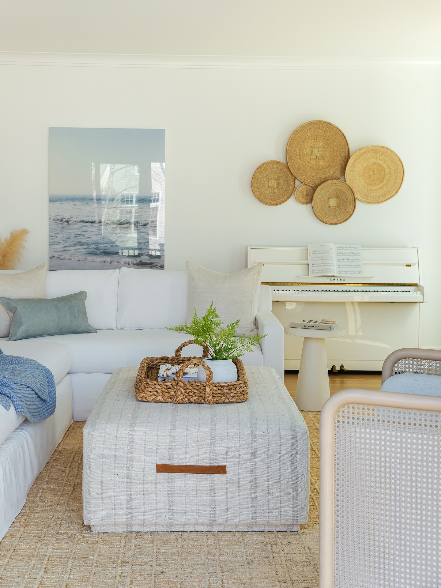 9. Add woven wall plates and a pale striped ottoman