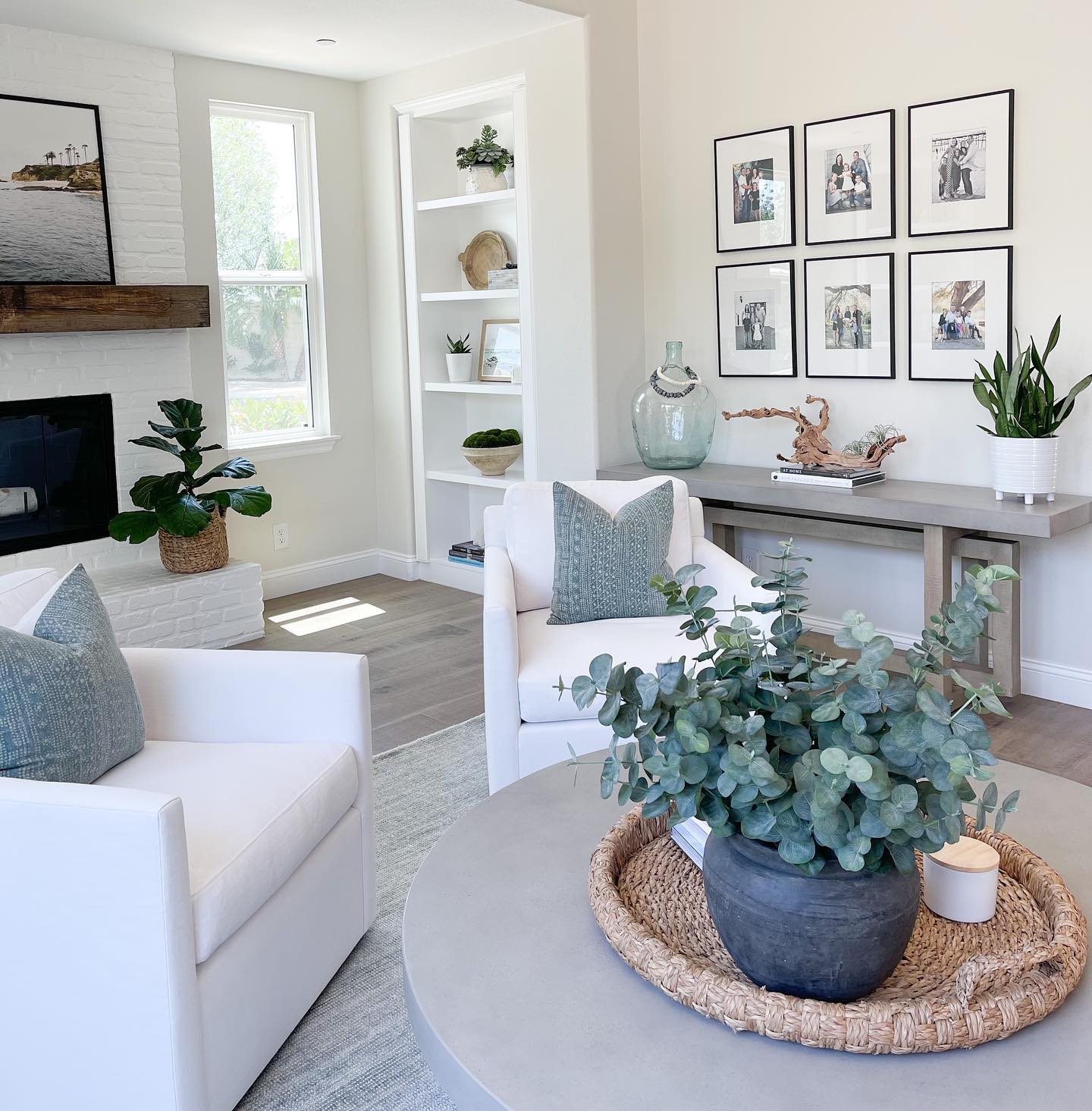 12. Pair crisp white armchairs with muted blue accents