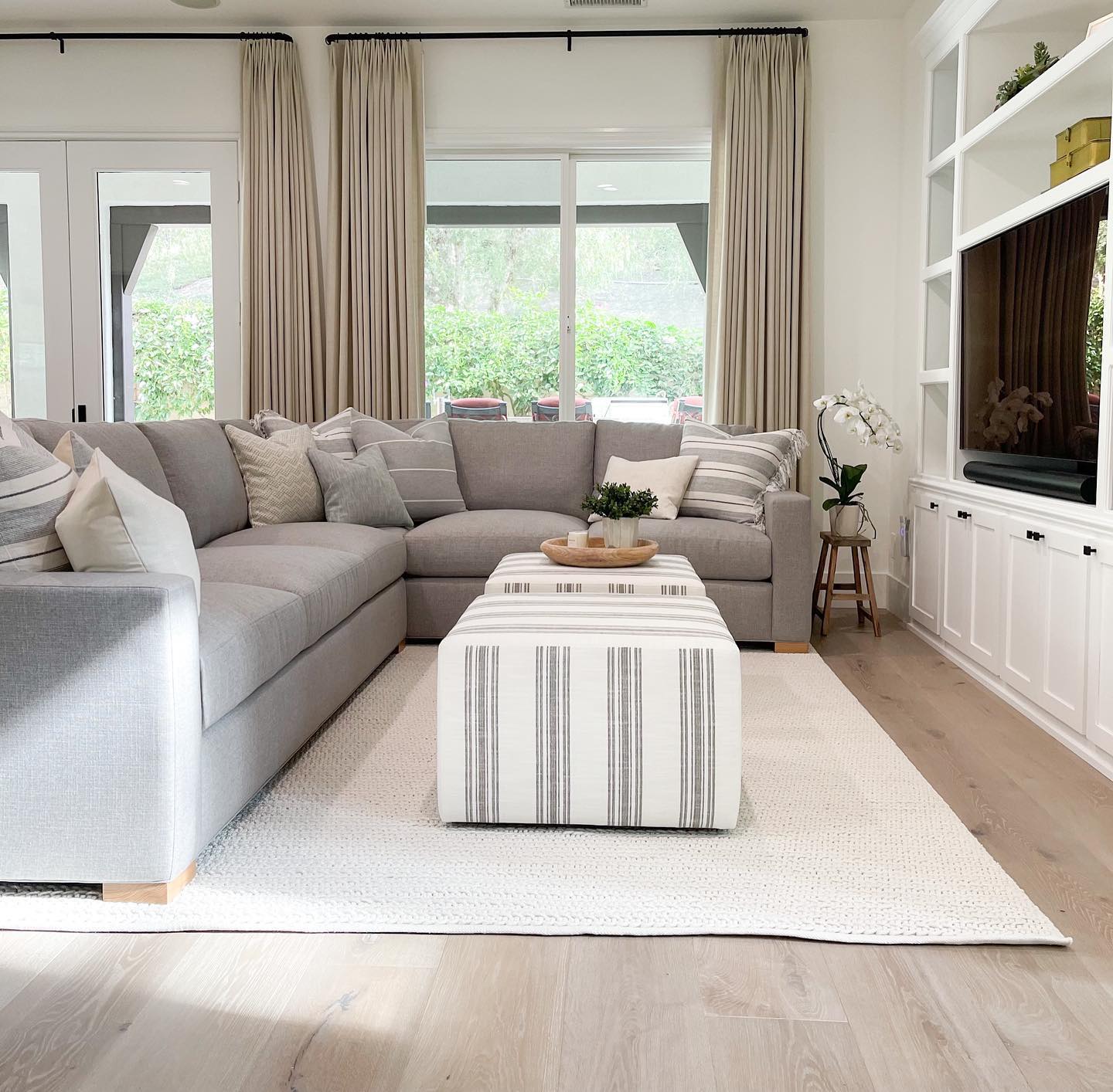 14. Build a pale gray lounge beside white media shelves