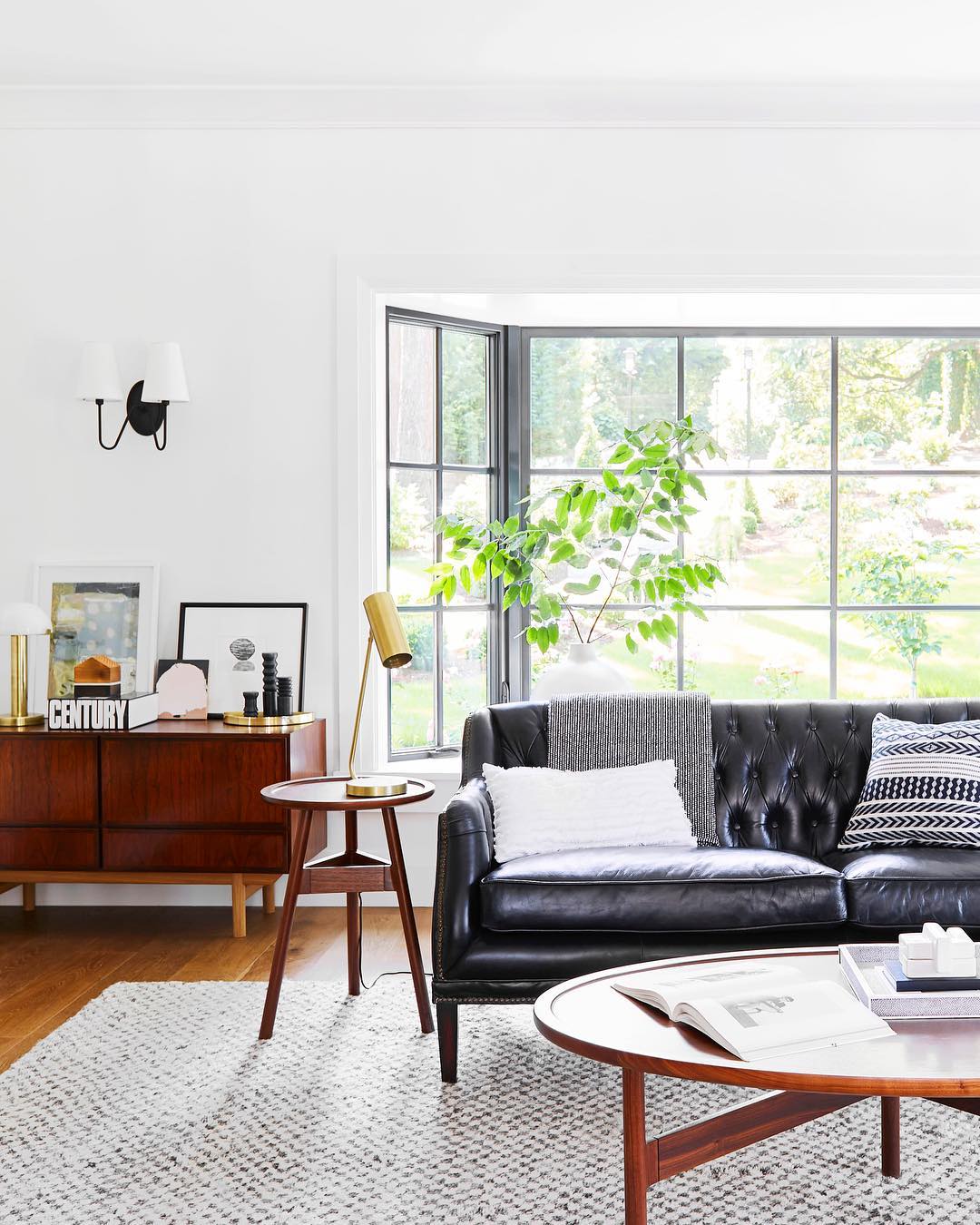 13. Lighten a Dark Sofa With Warm Wood