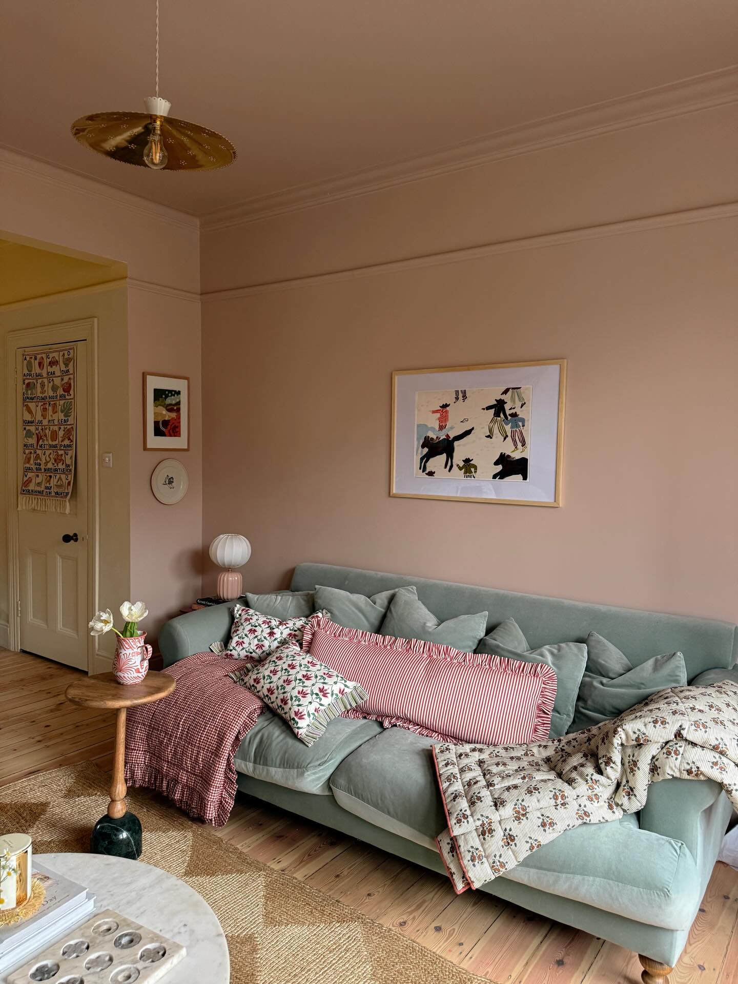 3. Layer Pink Patterns Over a Soft Blue Sofa