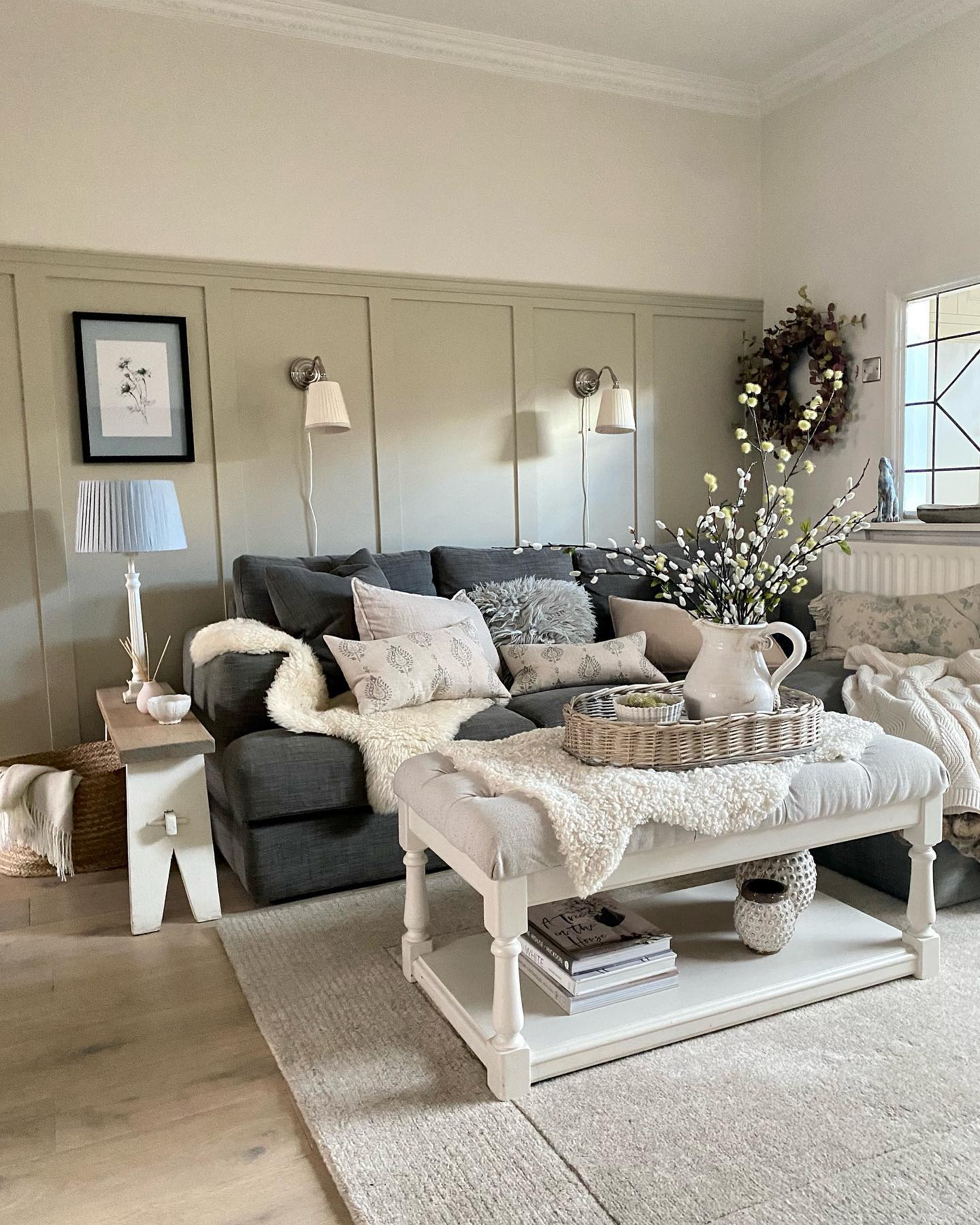 4. Add Quiet Sage Paneling Behind a Charcoal Sofa