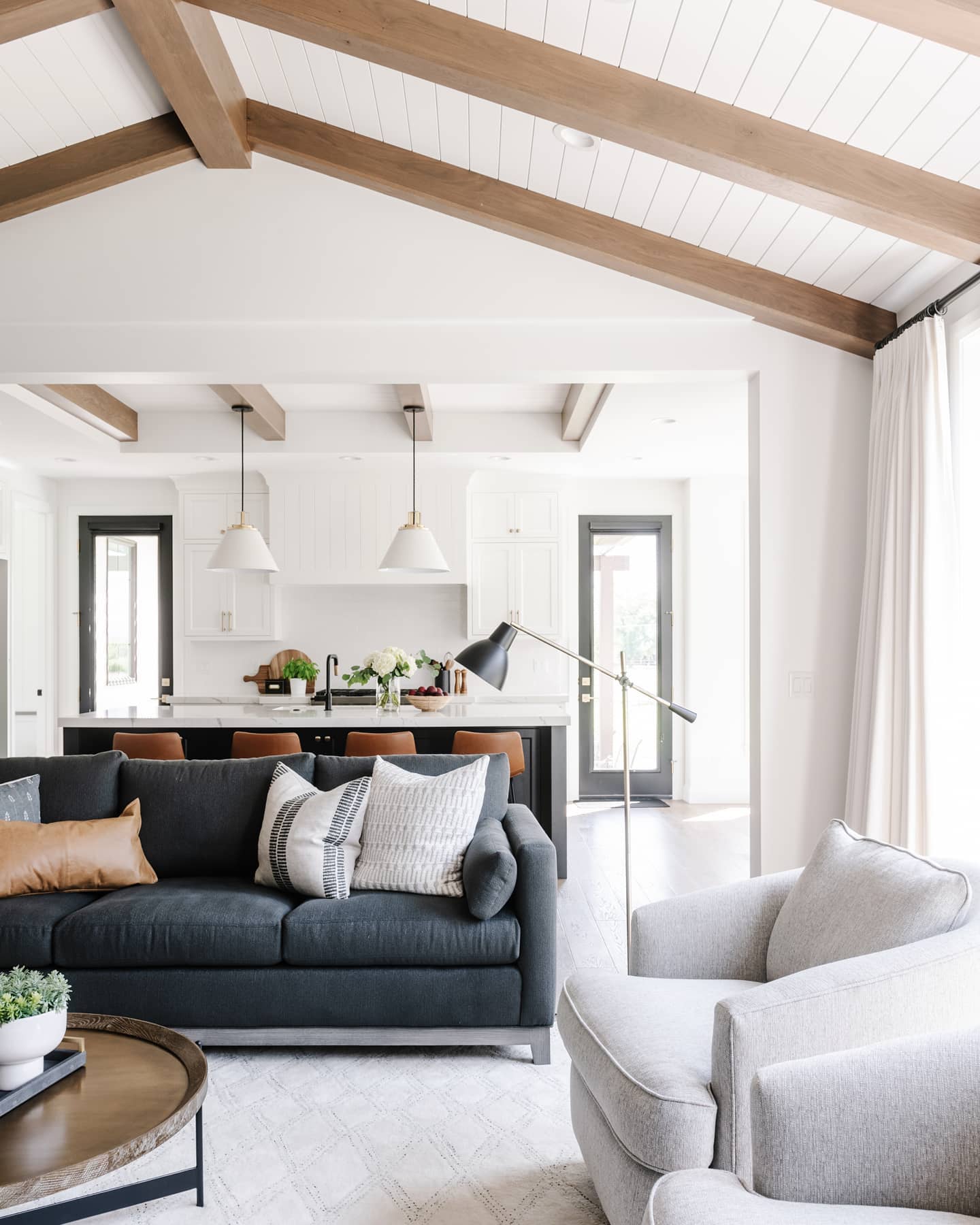 Repeat Wood Tones Across Changing Ceiling Heights