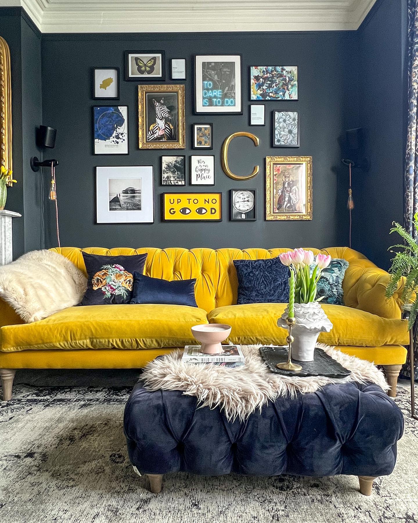 10. Build a Mixed Gallery Above a Golden Tufted Sofa
