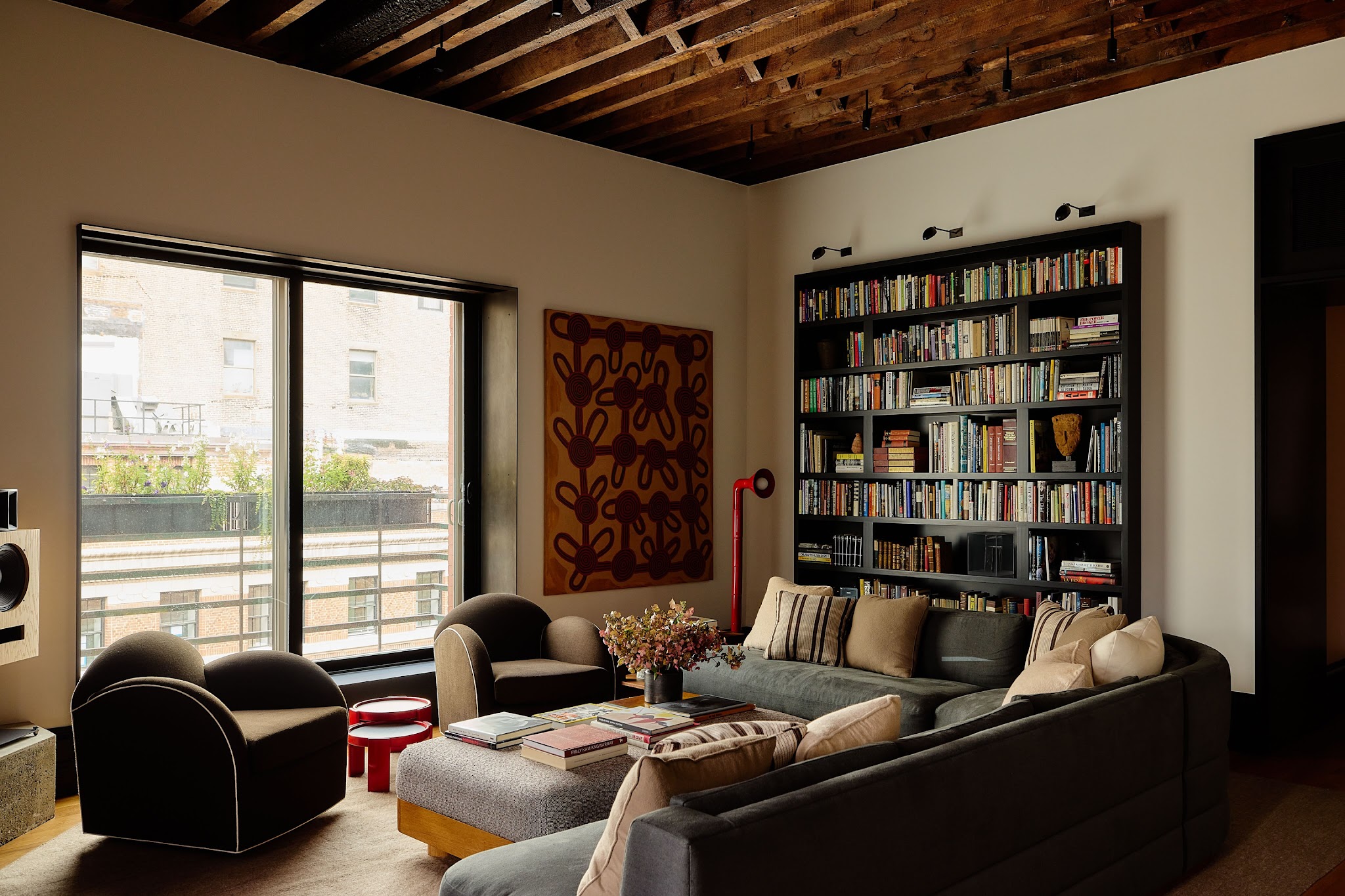 13. Contrast a Black Bookcase With an Exposed Brown Ceiling