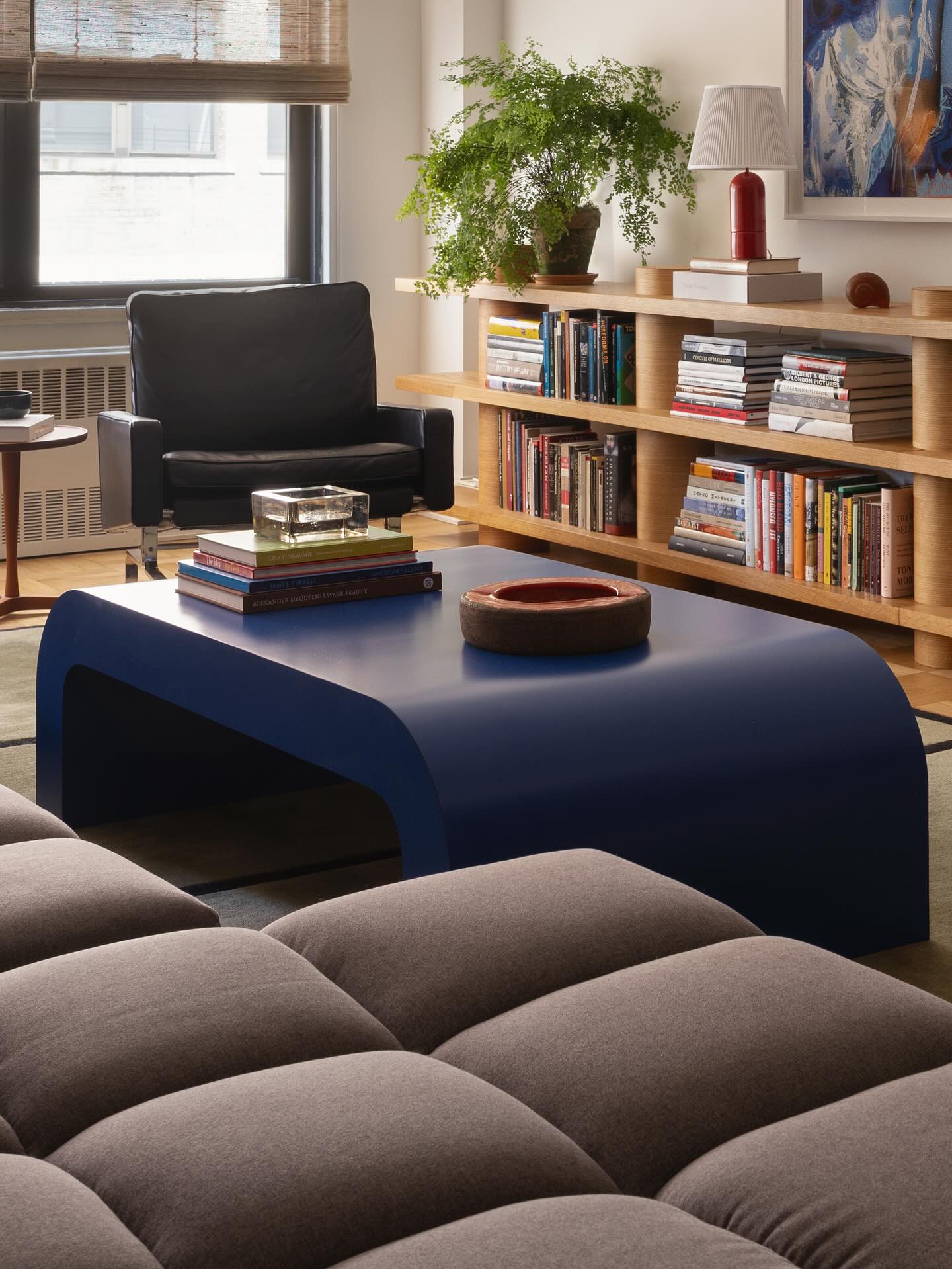 15. Anchor Brown Seating and Shelves With a Black Armchair