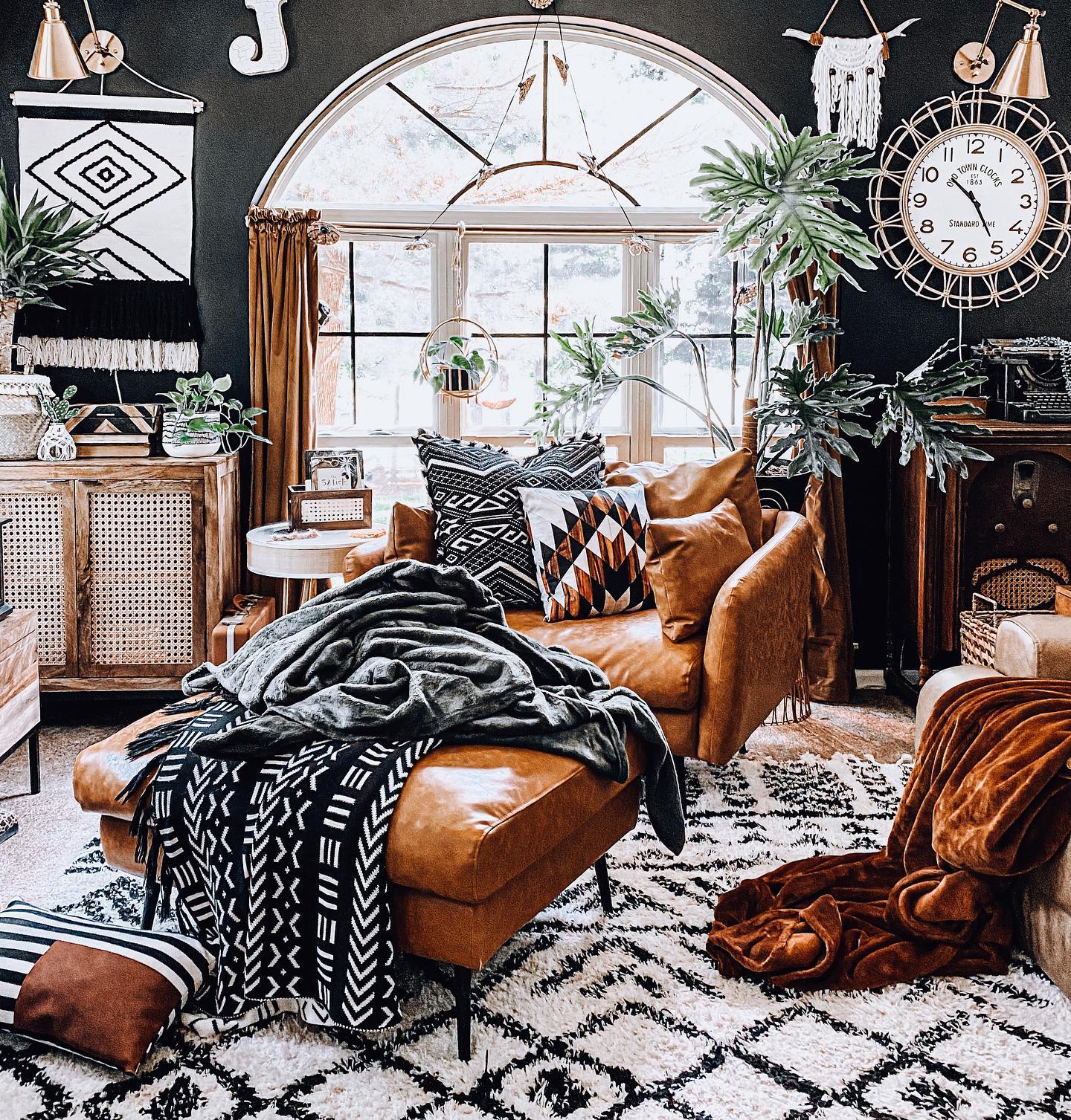 5. Warm Black Walls with Brass Wall Lights