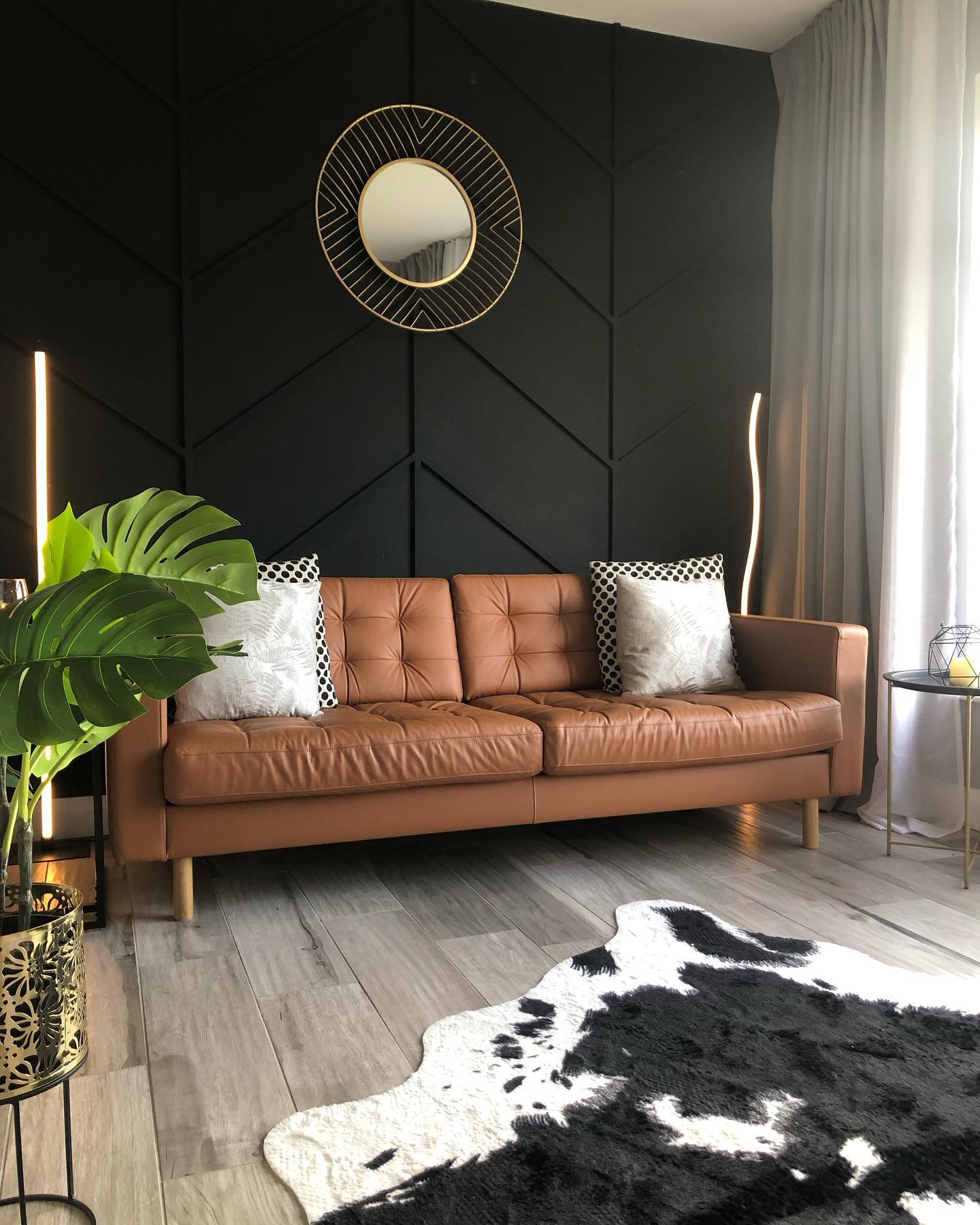 11. Outline a Black Wall with a Round Gold Mirror