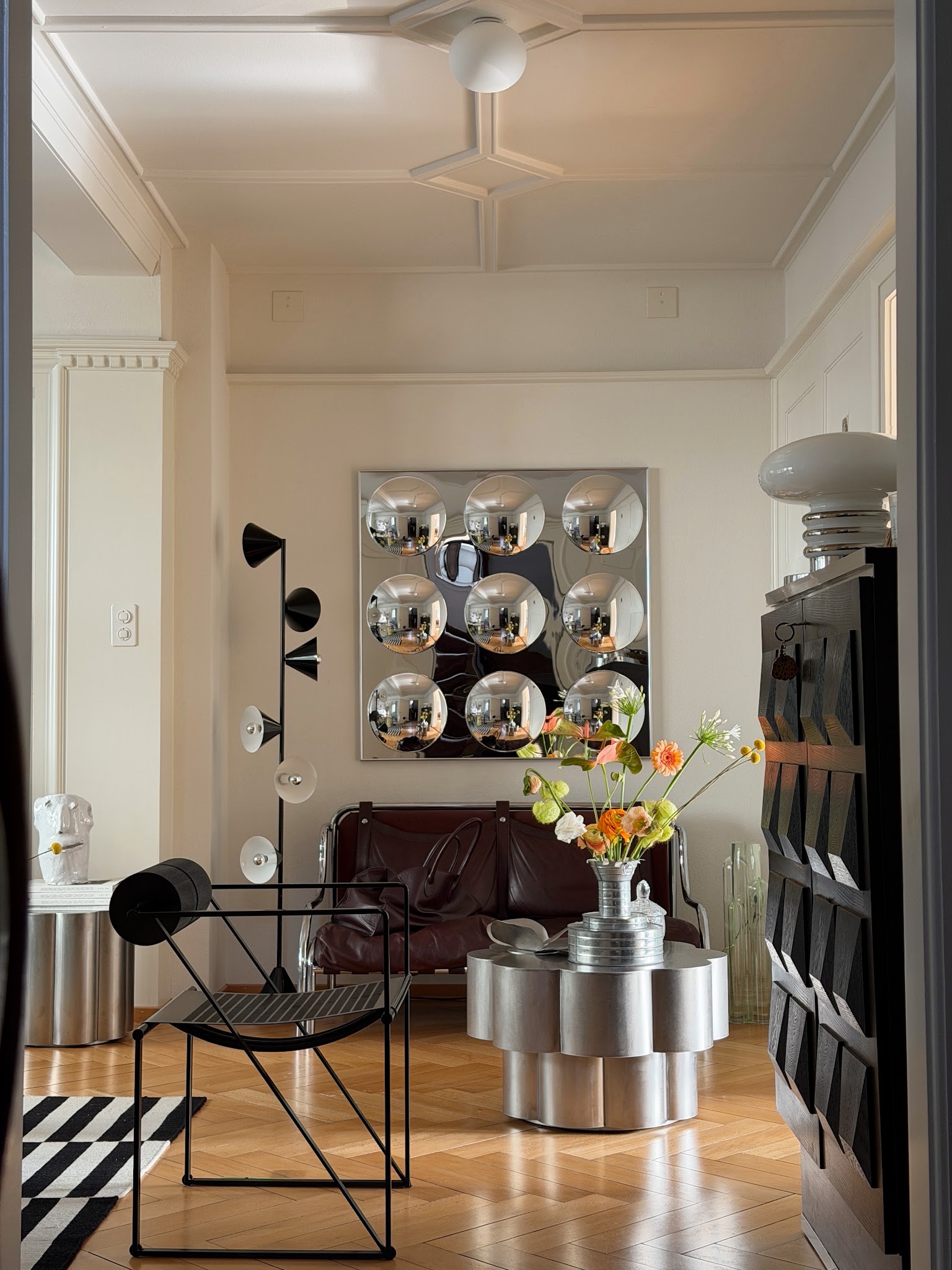 5. Contrast a Sculptural Silver Table With Black Storage