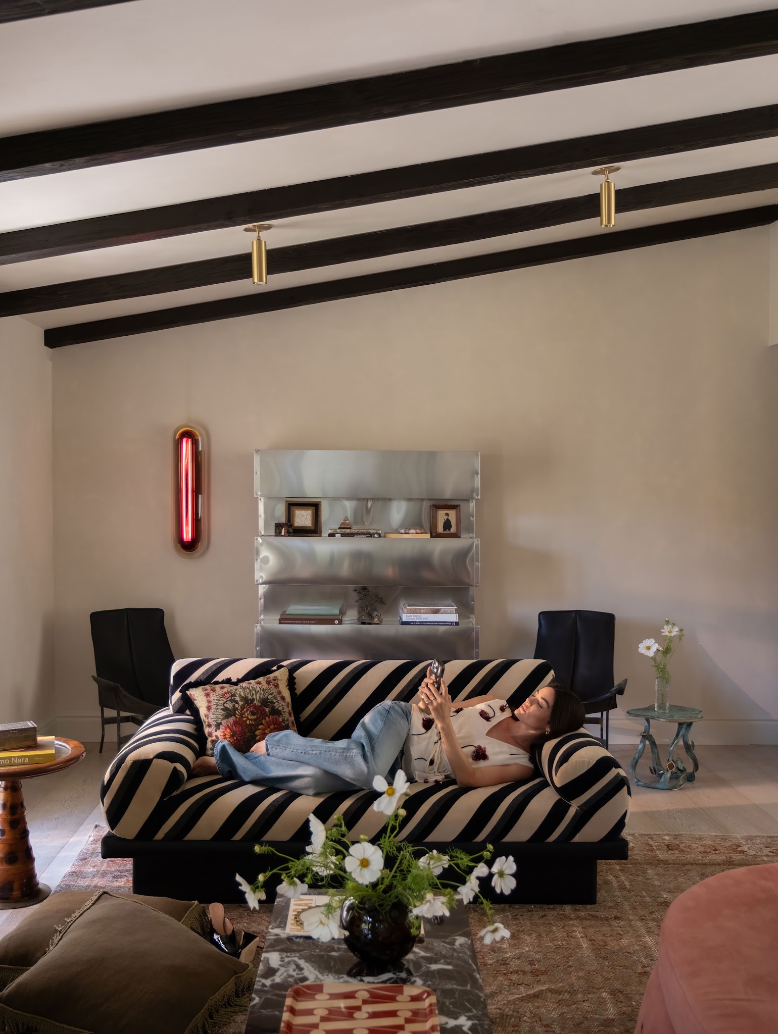 13. Place Silver Shelving Behind a Black Patterned Sofa