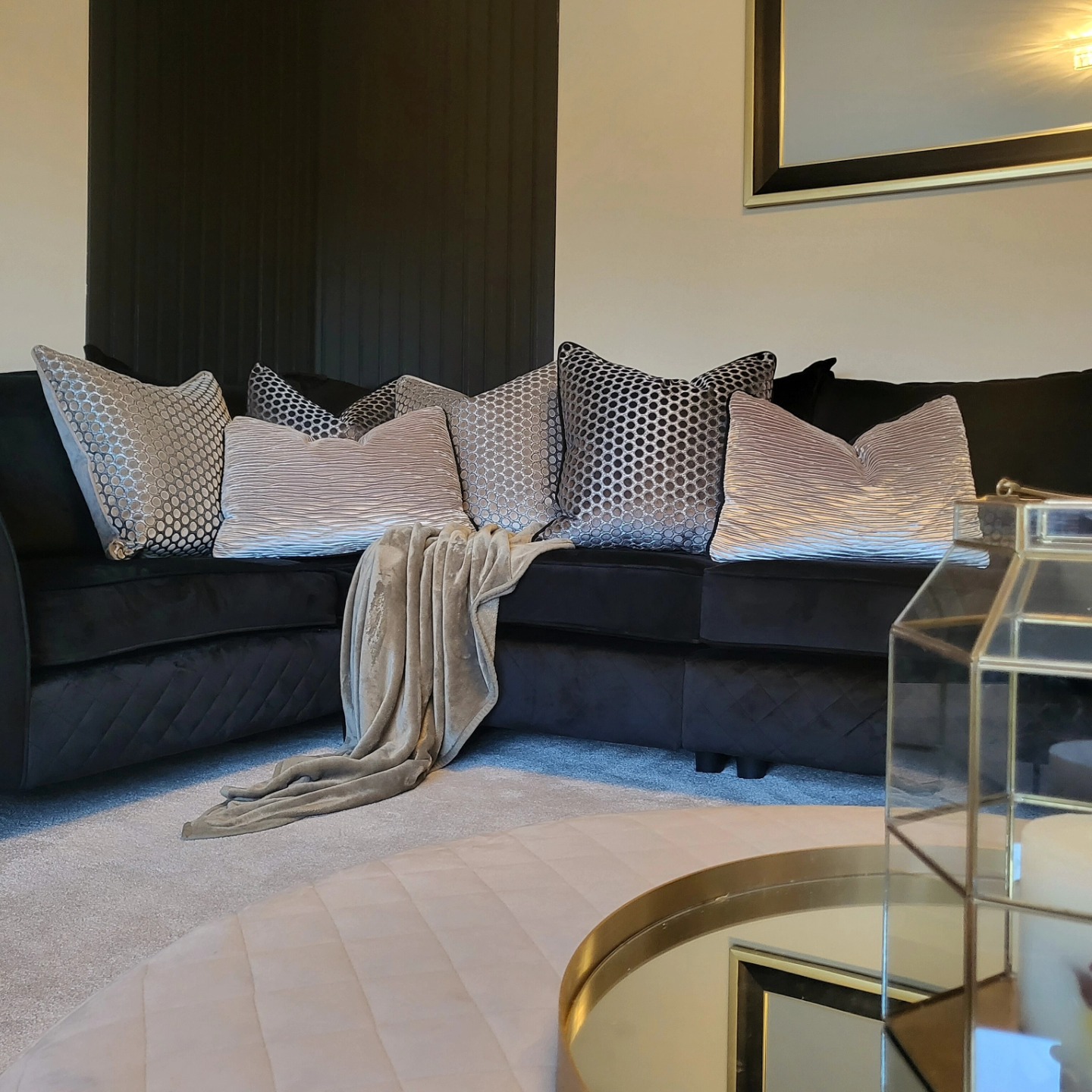 11. Soften a Black Corner Sofa With Layered Neutrals