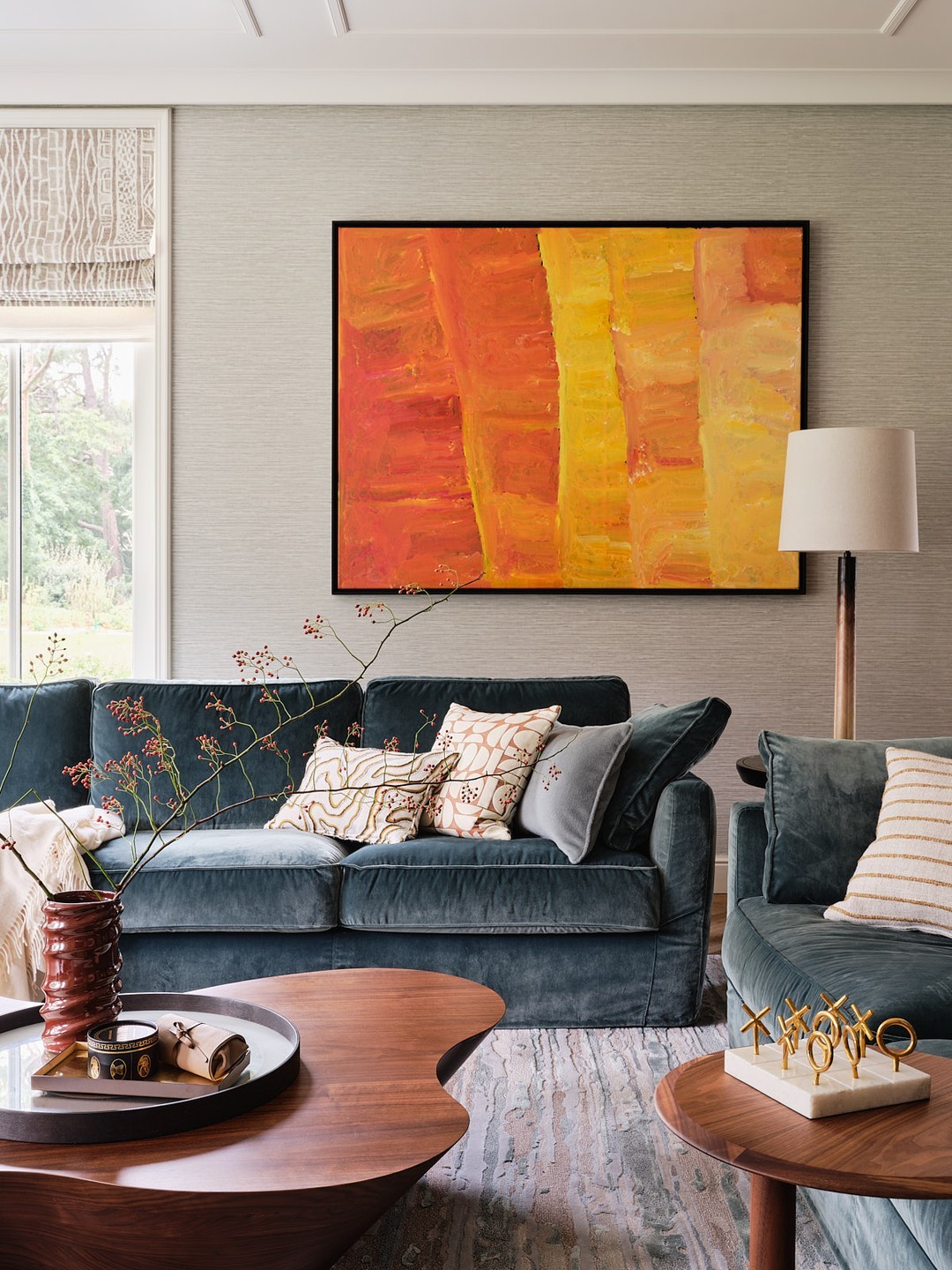 19. Soften Orange Artwork With Smoky Blue Seating
