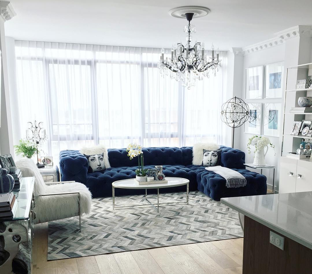 17. Frame a Navy Sofa With Sheer White Curtains