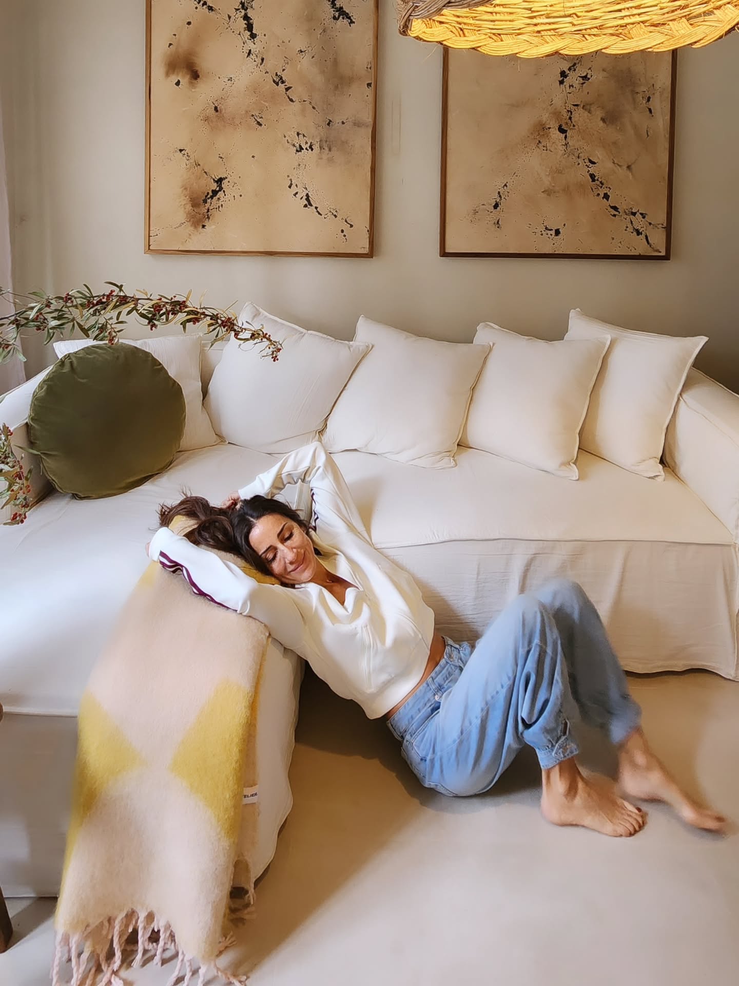4. Pair Earthy Abstract Art Above a Pale Sofa
