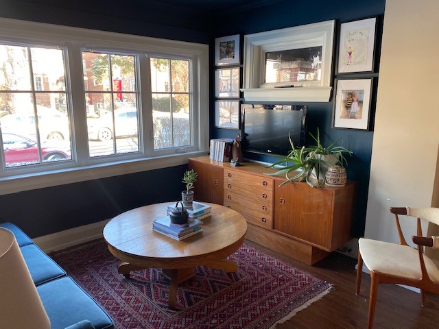7. Give Navy Walls a Warm Wooden Media Cabinet