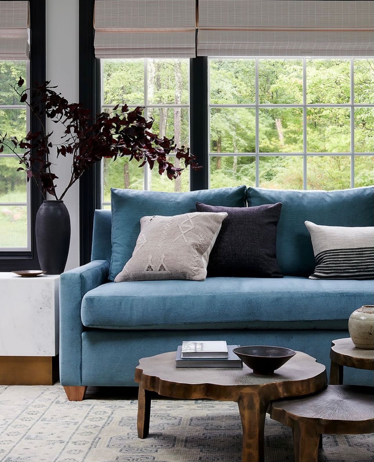 10. Combine a Blue Sofa With Organic Brown Tables