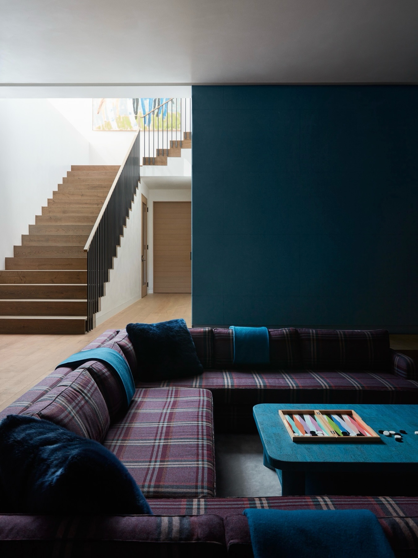 12. Set a Blue Seating Nook Beside Warm Wood Stairs