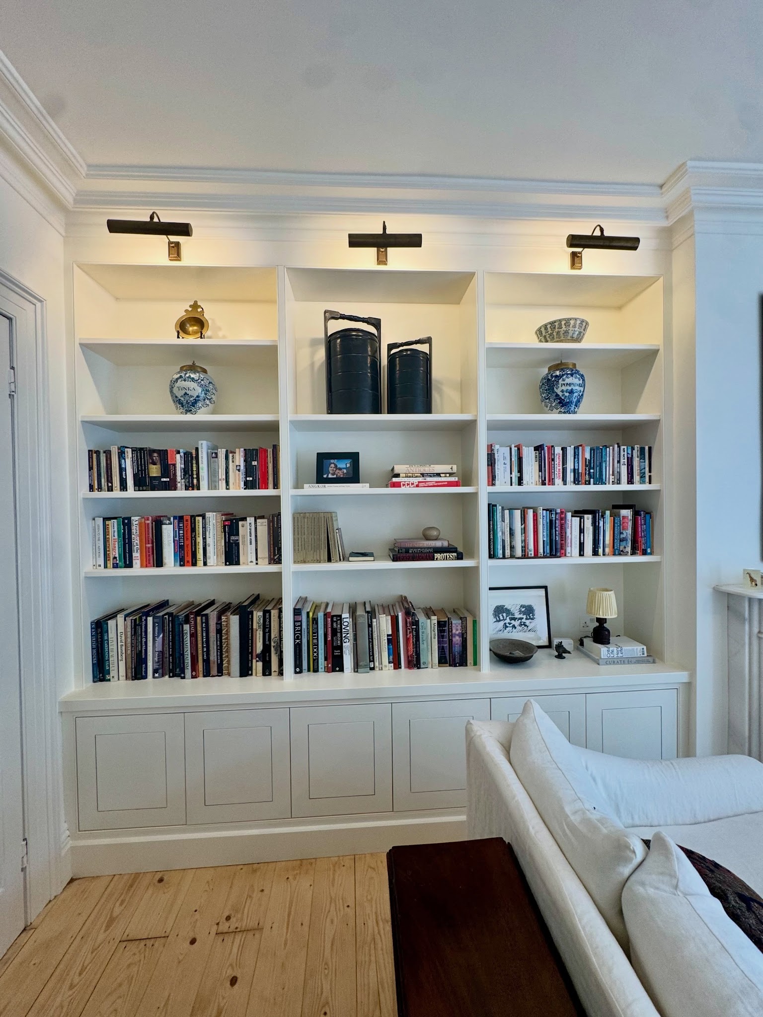 19. Add Picture Lights Above Each Shelving Bay