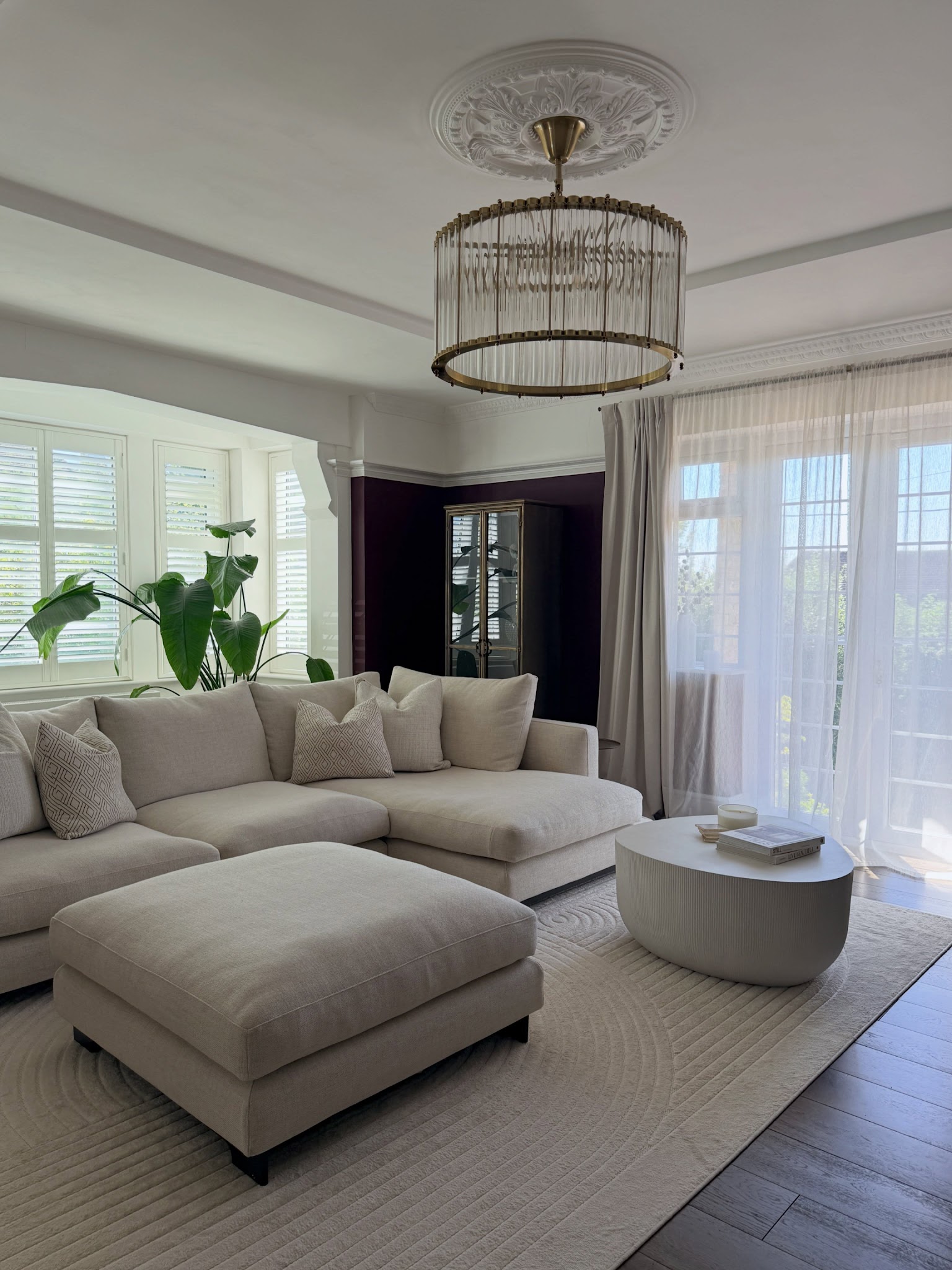 7. Keep an Aubergine Room Bright with Ivory Upholstery