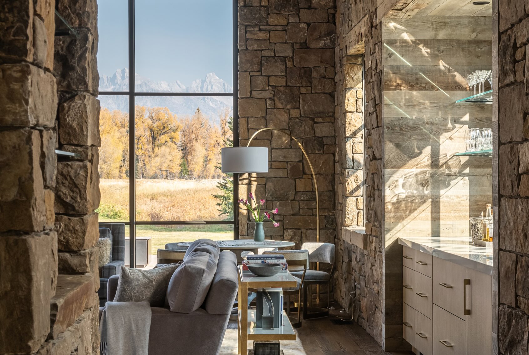 13. Glass Shelves Beside Rustic Stone