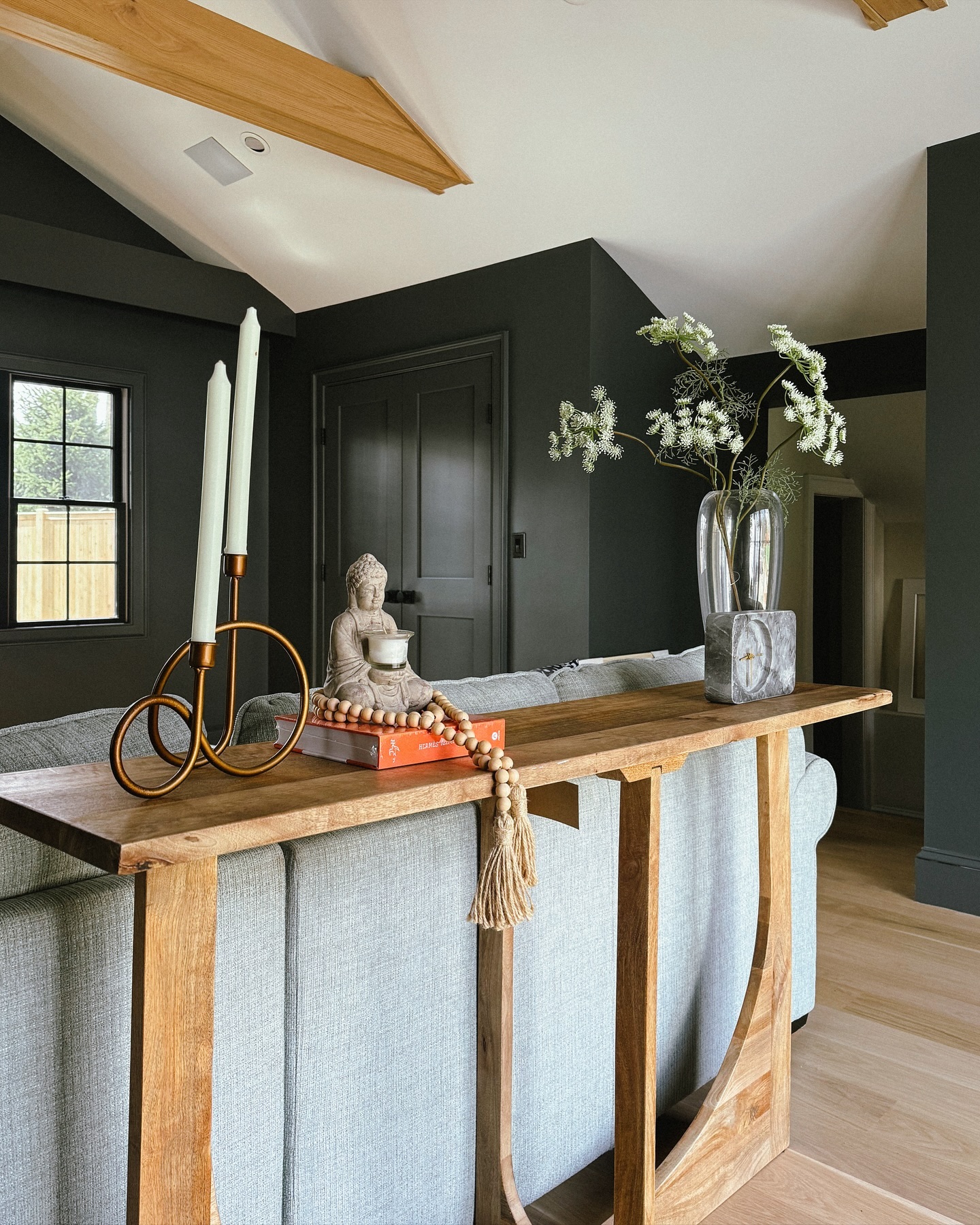 15. Warm Wood Against Deep Green Walls