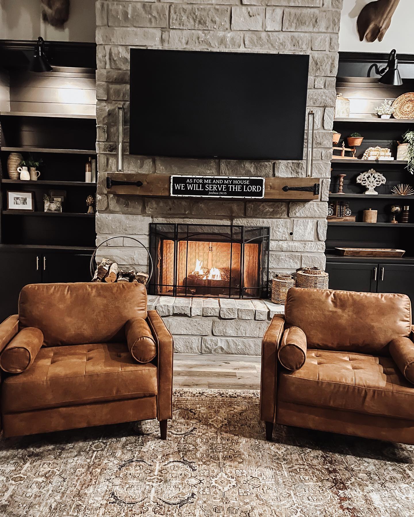 11. Set Worn Leather Chairs Beside a Stone Fireplace