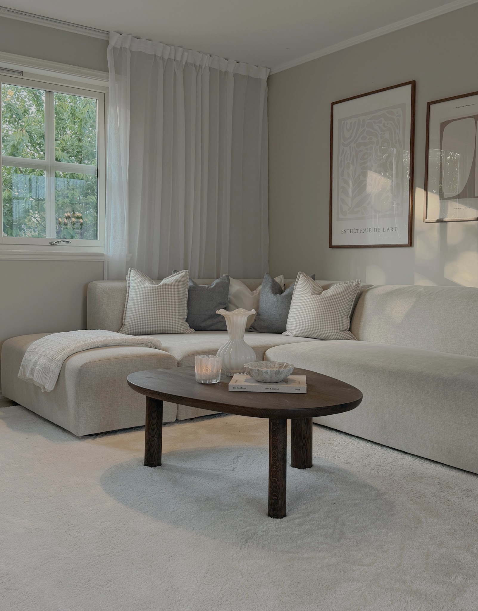 10. Frame a Beige Sectional With Sheer Curtains