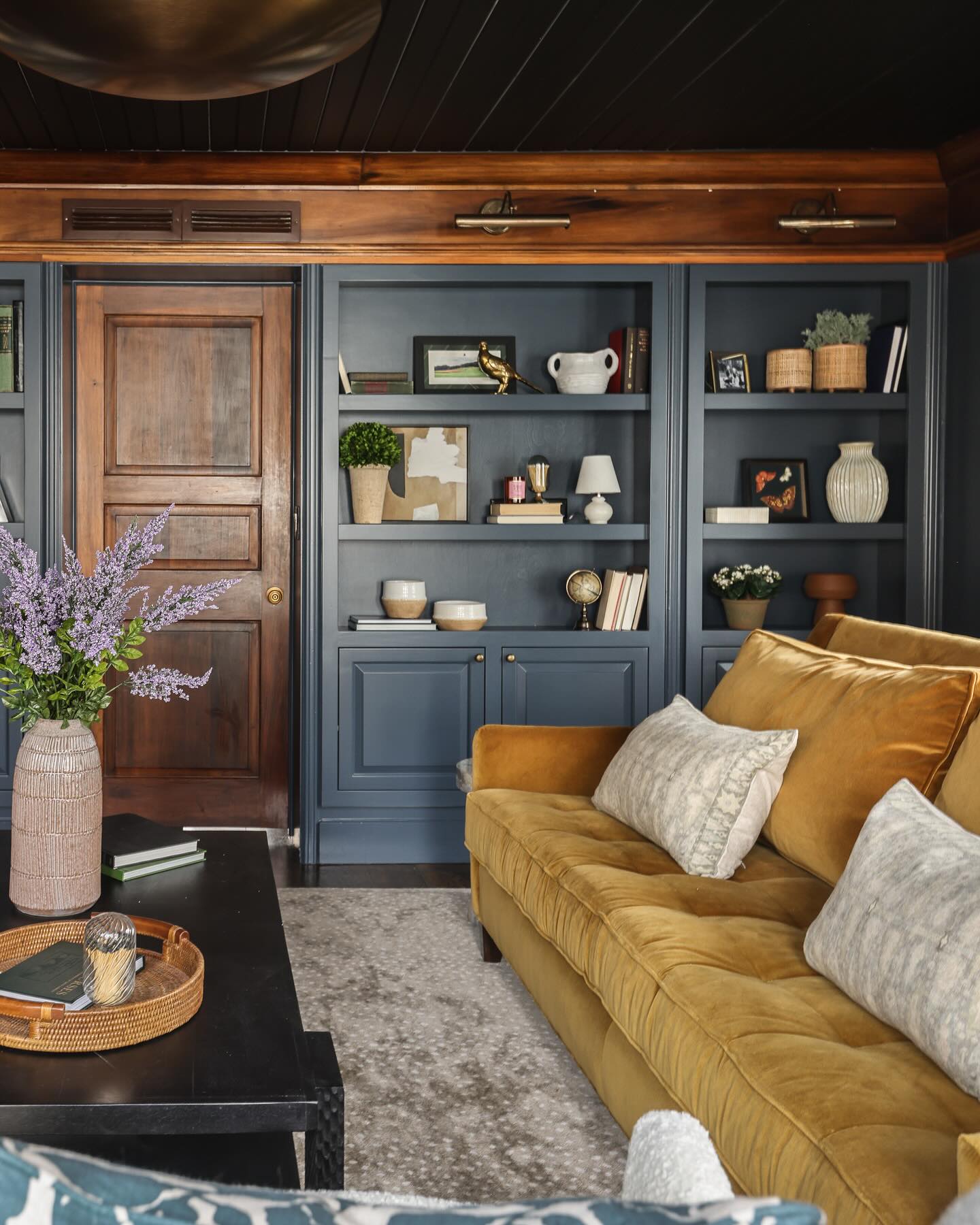 3. Keep Warm Wood Visible Beside Dark Shelving