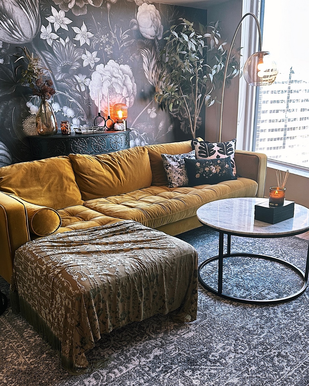 9. Use a Dark Botanical Wall Behind Warm Velvet
