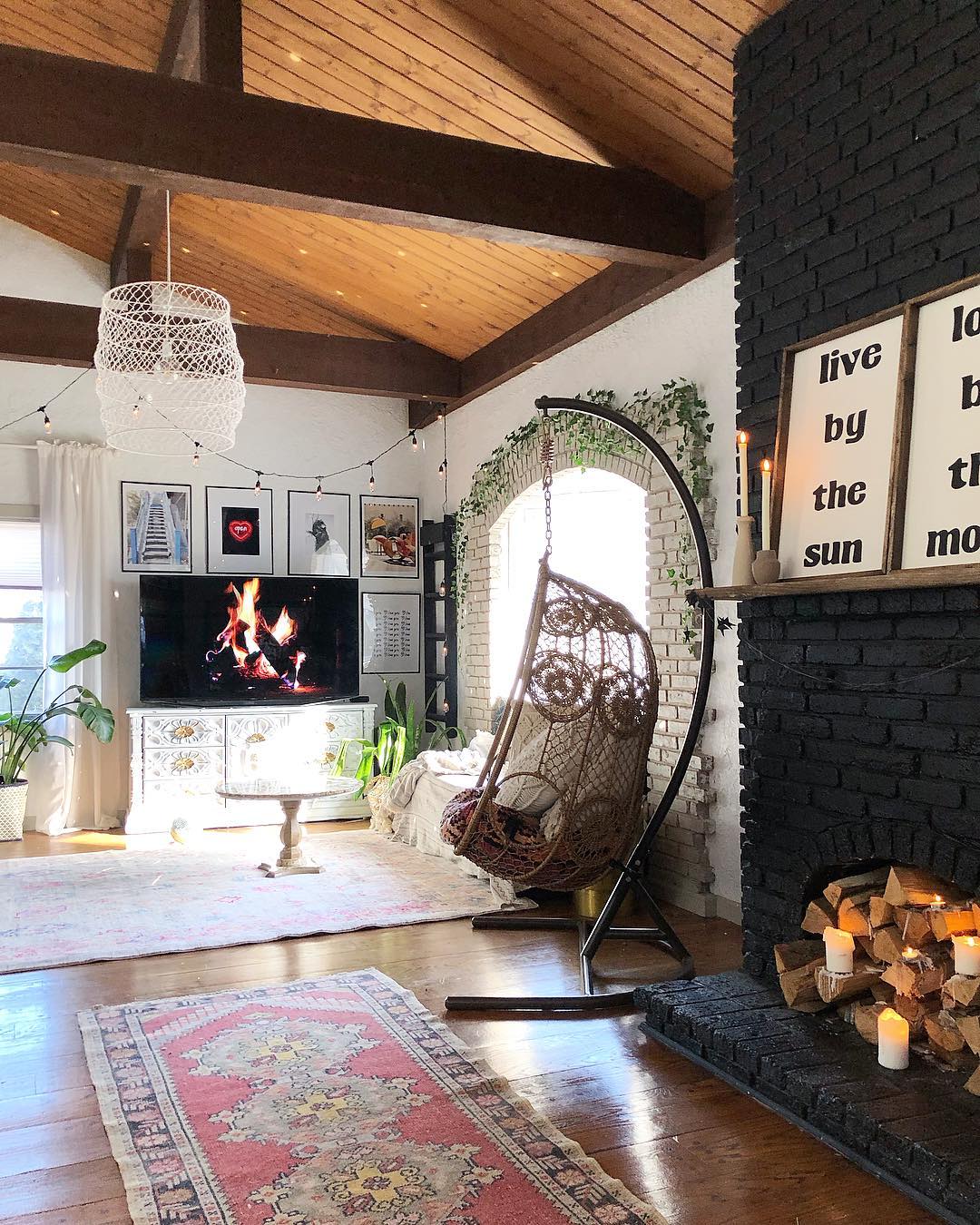 9. Soften a Black Fireplace With a Woven Chair