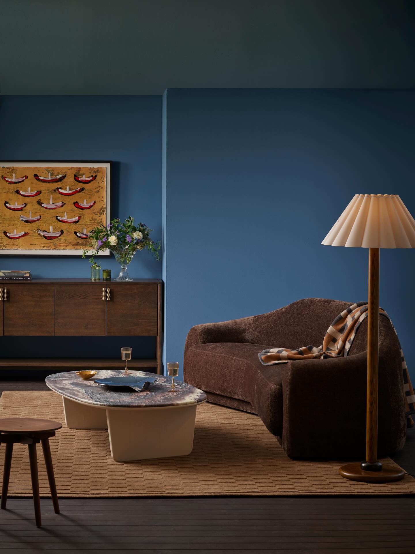 13. Pair Chocolate Upholstery With a Rich Blue Backdrop