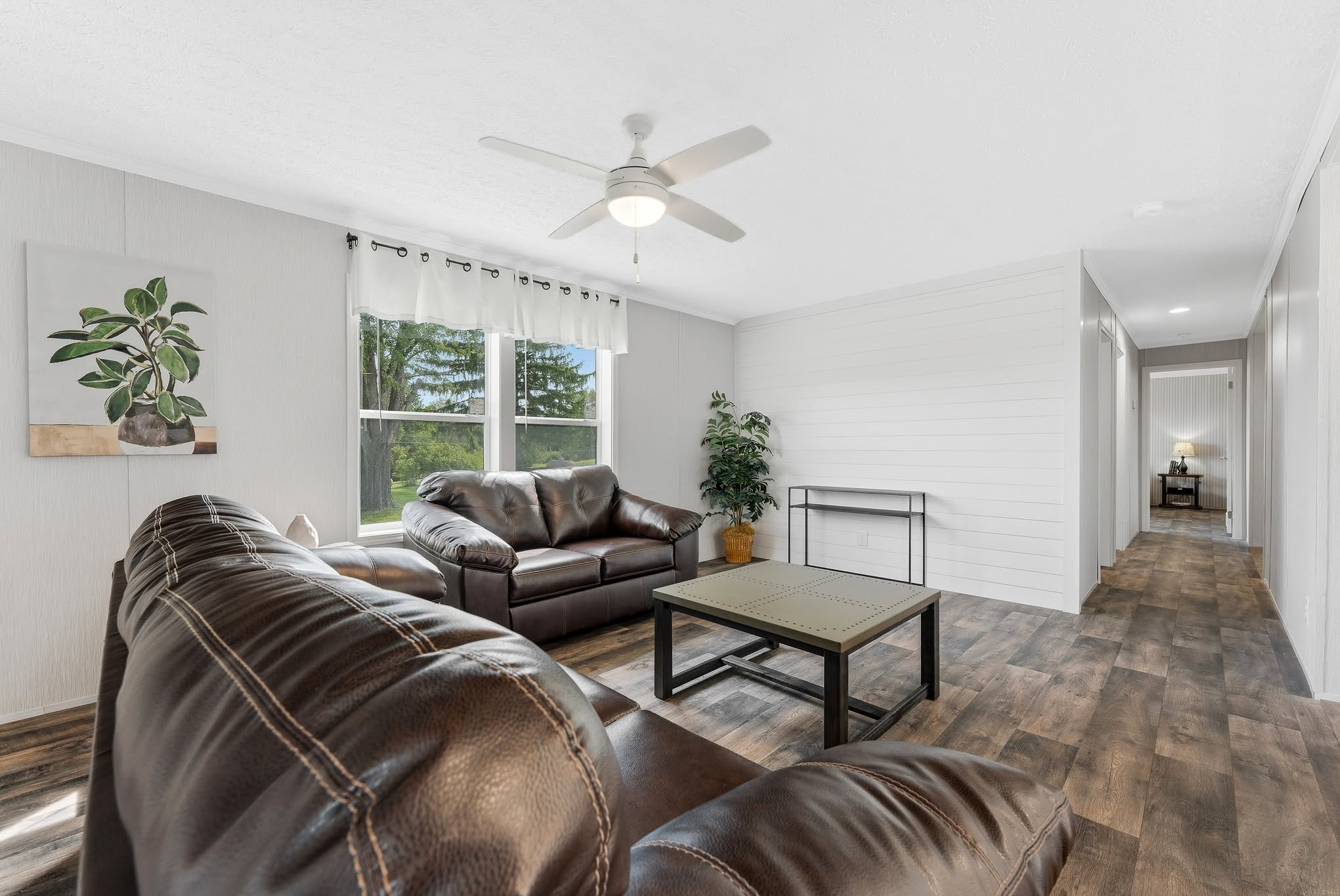 15. Keep the Walls Bright Around a Brown Sofa Pair