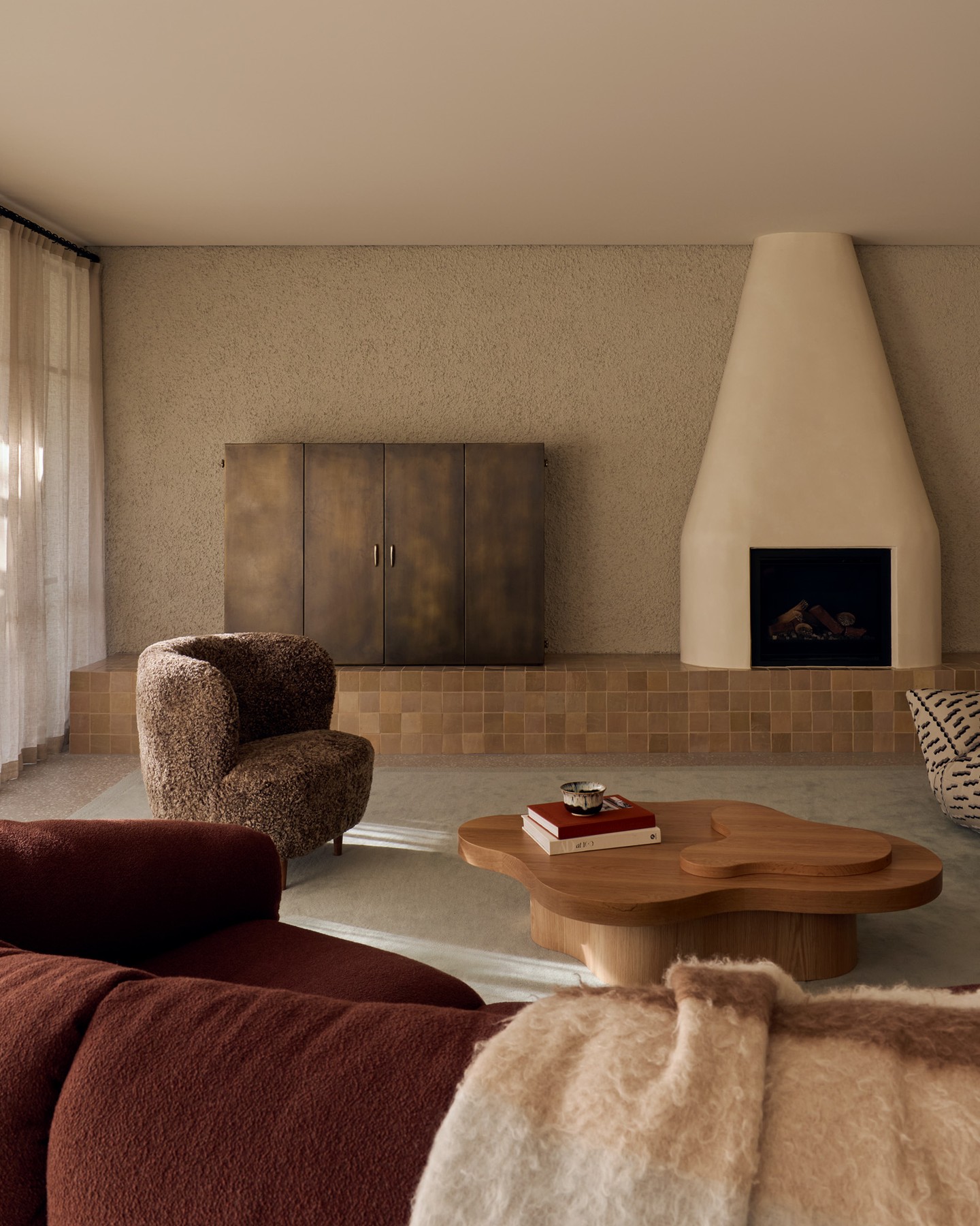 7. Mix Sandy Texture With Sculptural Wood and Deep Brown