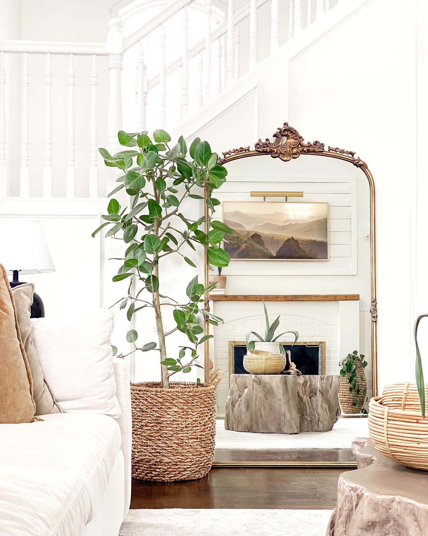 10. Reflect Greenery Beside a Natural Wood Accent Table