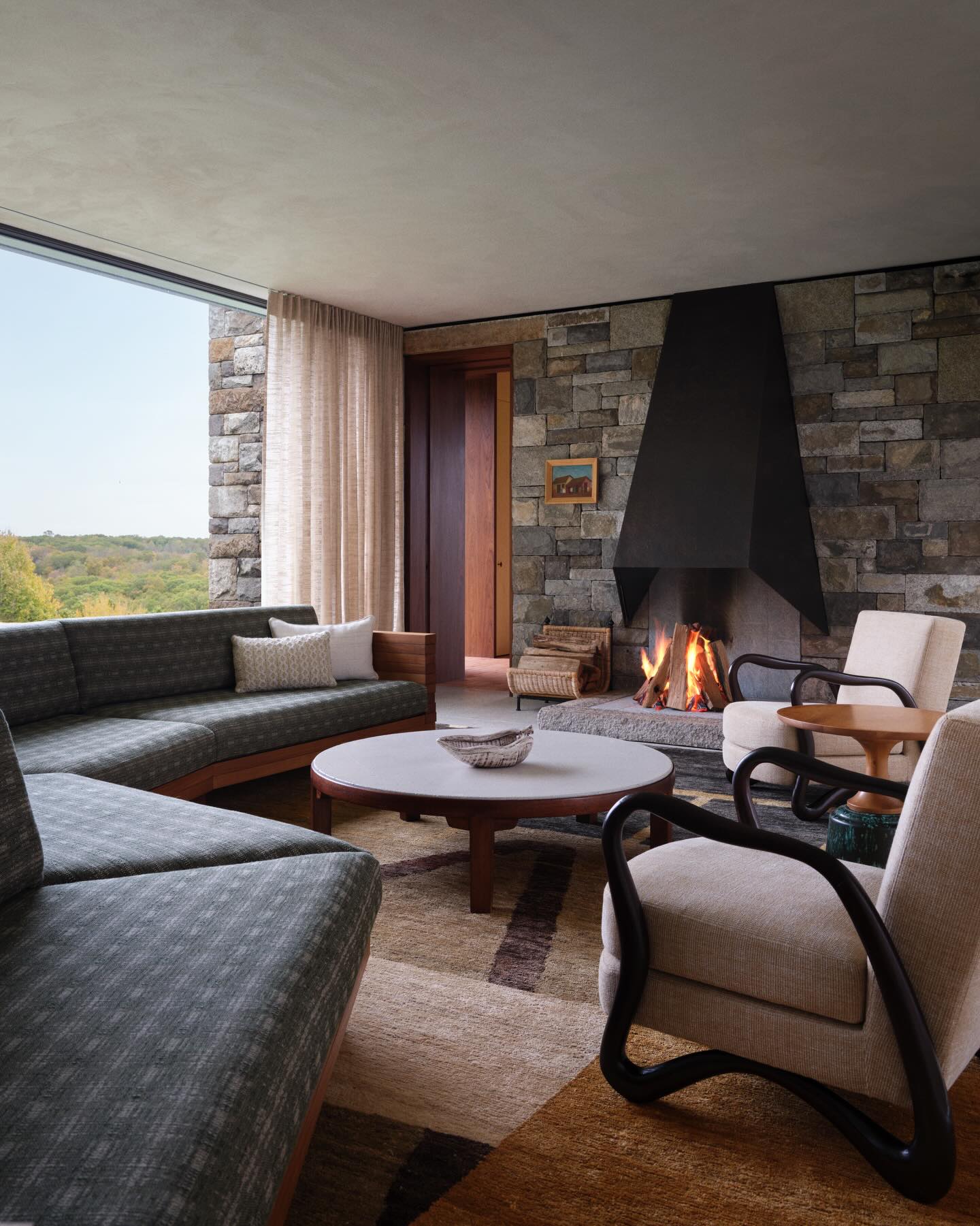 15. Balance a Rough Fireplace Wall With Flowing Chair Frames