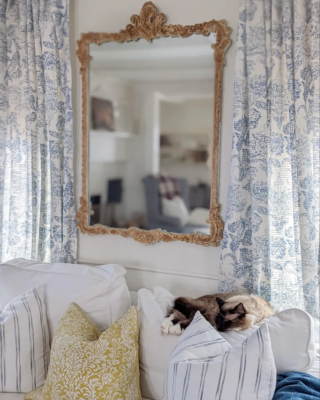12. Frame a Gilt Mirror With Blue Patterned Curtains