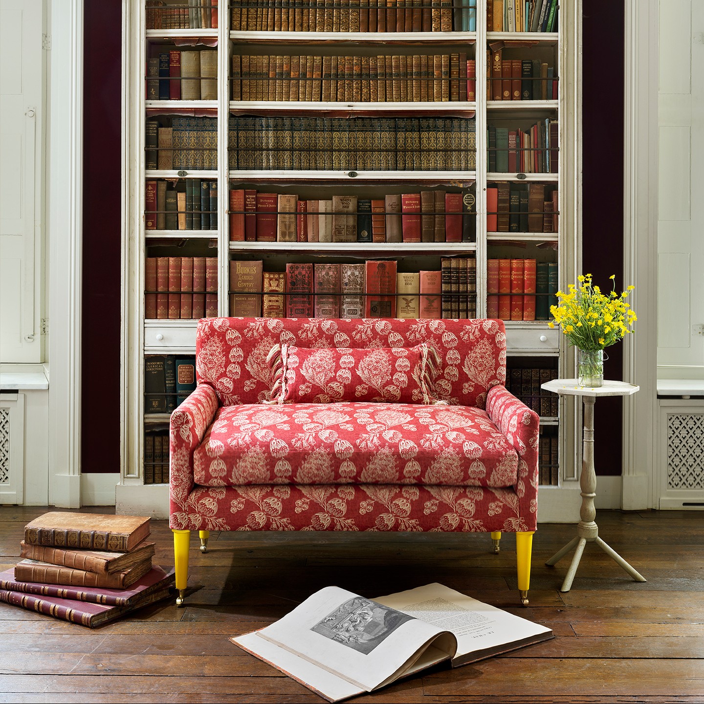 14. Tuck a Floral Loveseat Against Bookshelves